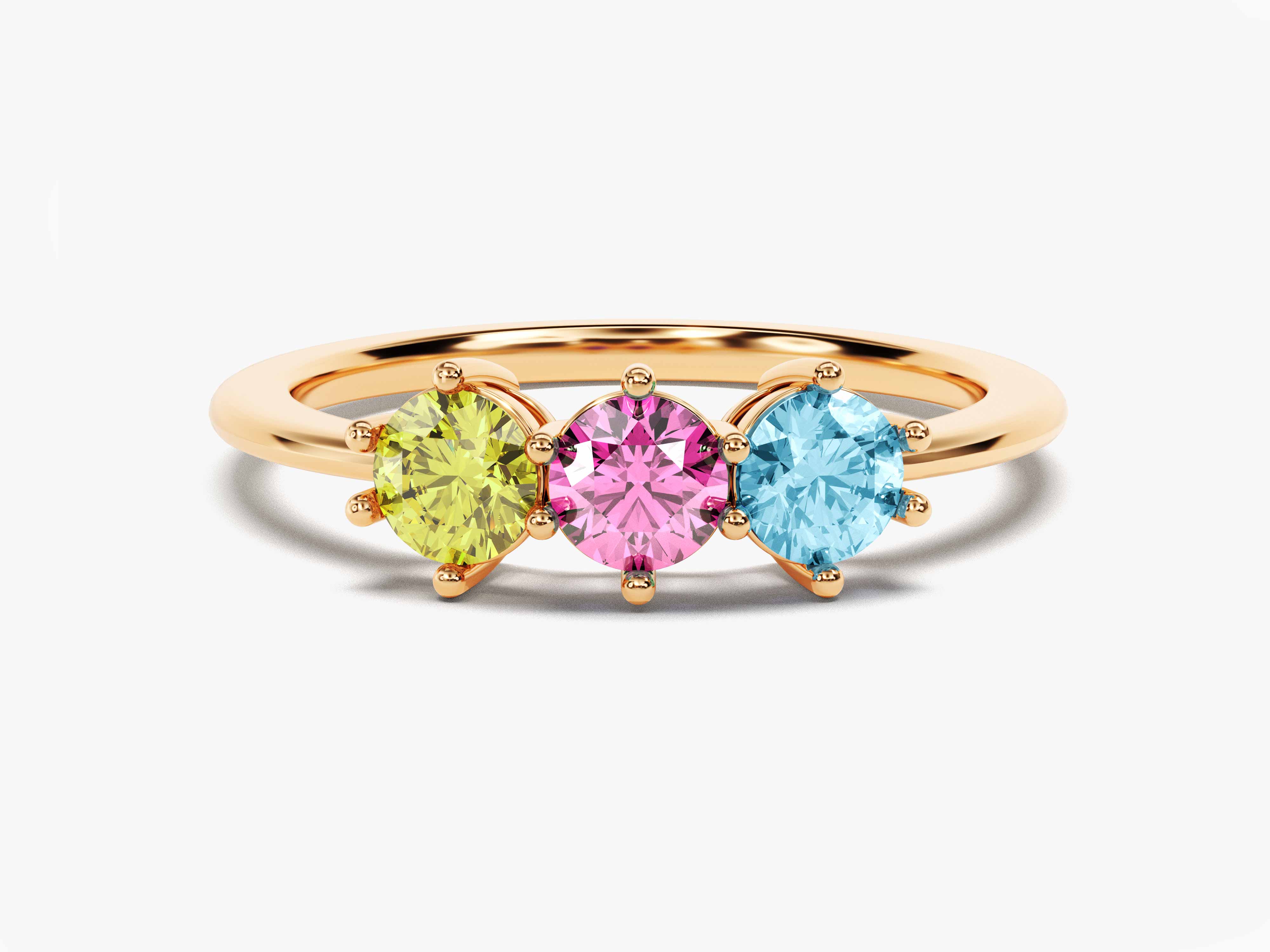 Gold ring with three colorful gemstones: yellow, pink, and blue