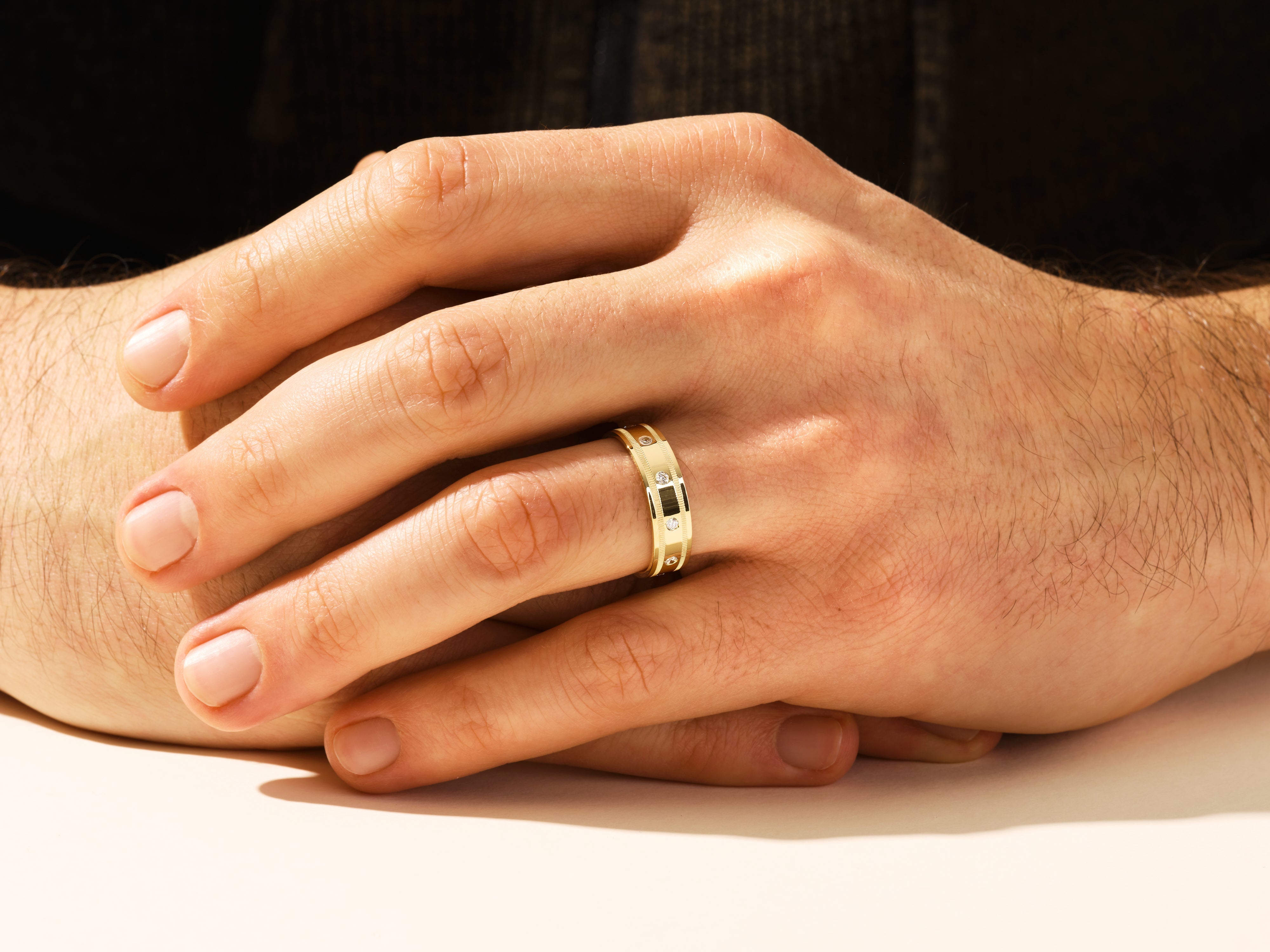 Gold ring with diamonds on a man's hand, jewelry for men