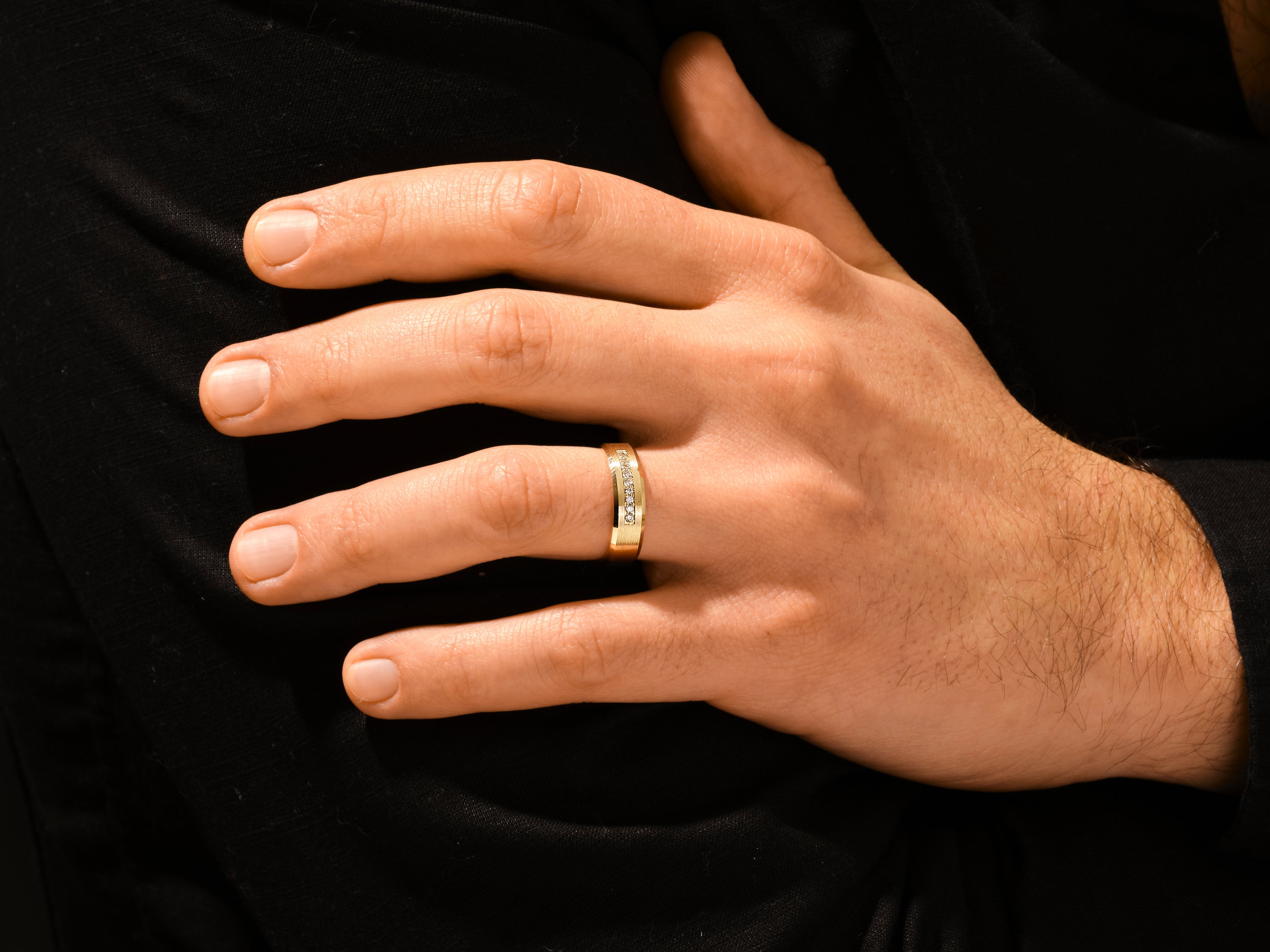 Gold diamond ring on a man's finger, jewelry