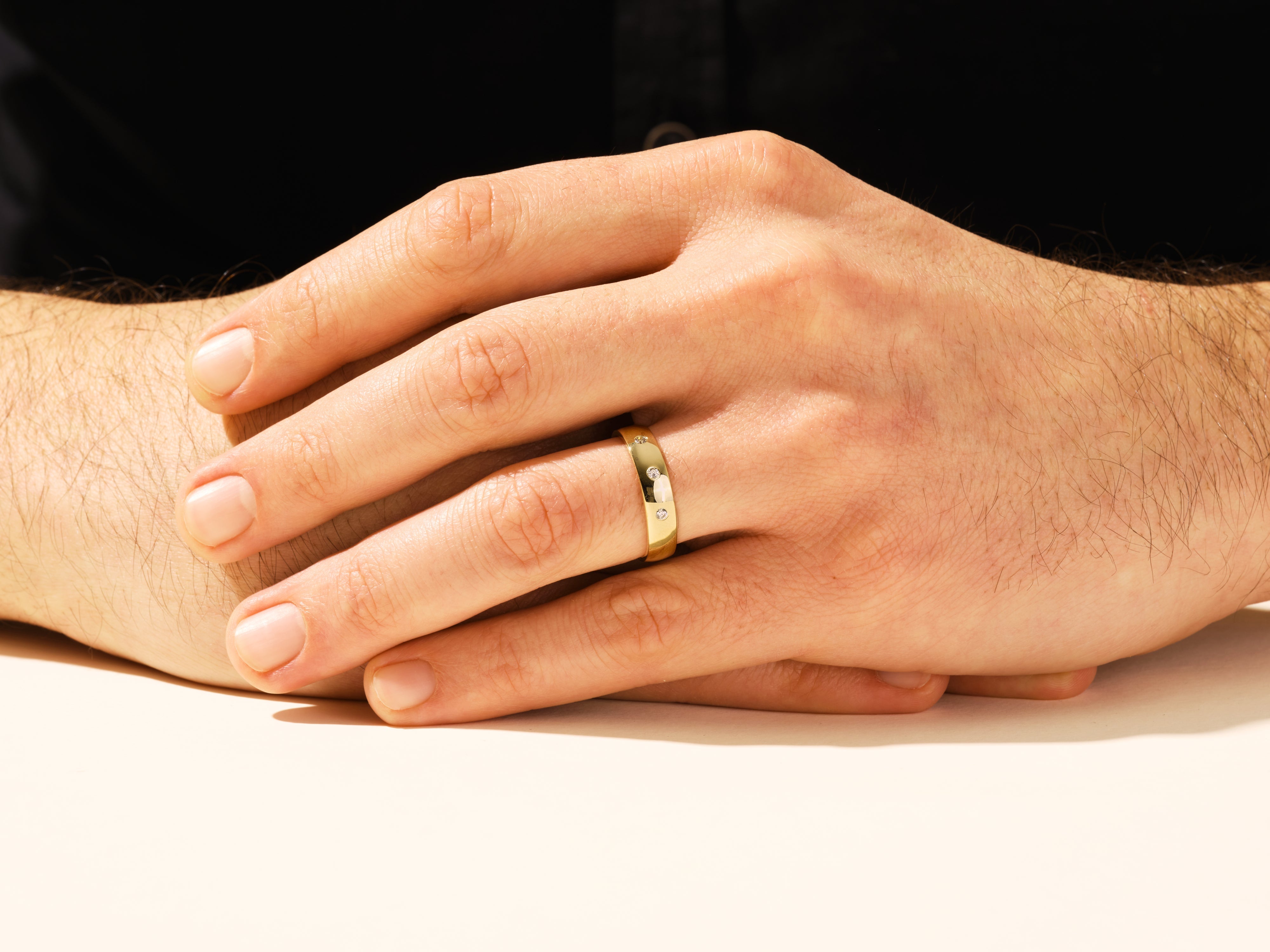 Diamond accented gold ring on a man's finger, jewelry product