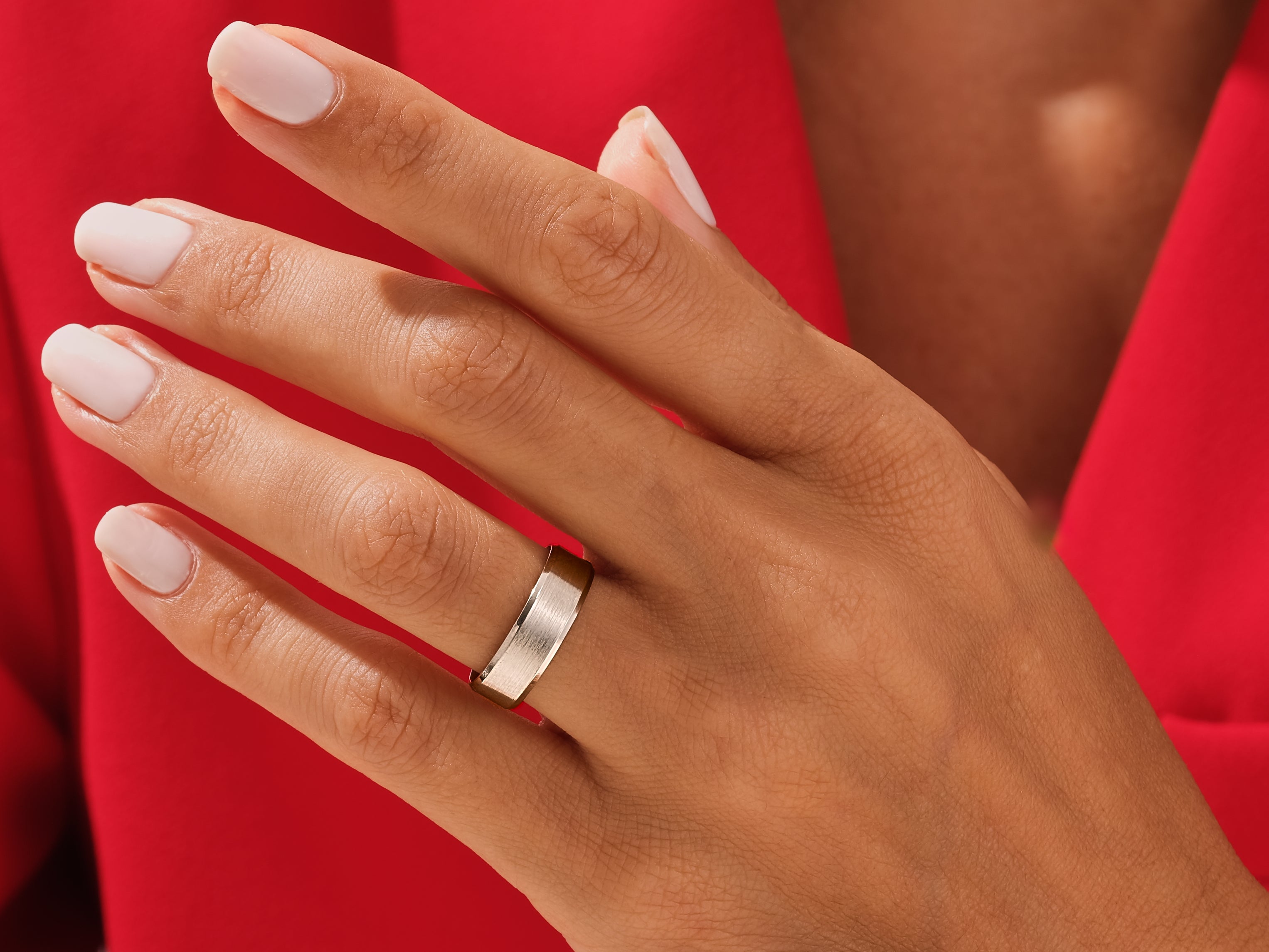 Elegant silver band ring on a hand, jewelry photography