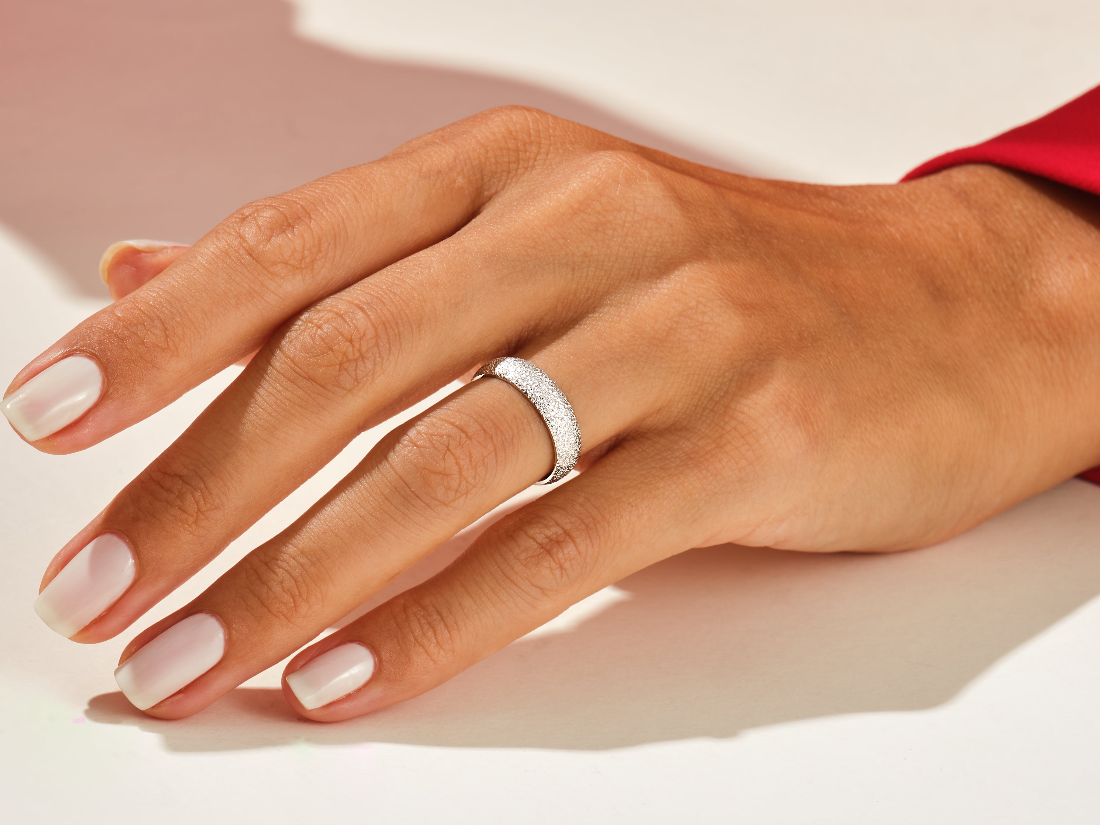 Diamond band ring on a woman's hand, jewelry photography