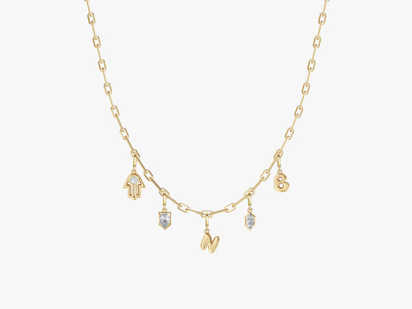 Gold necklace with charms: Hamsa, letters, and diamonds