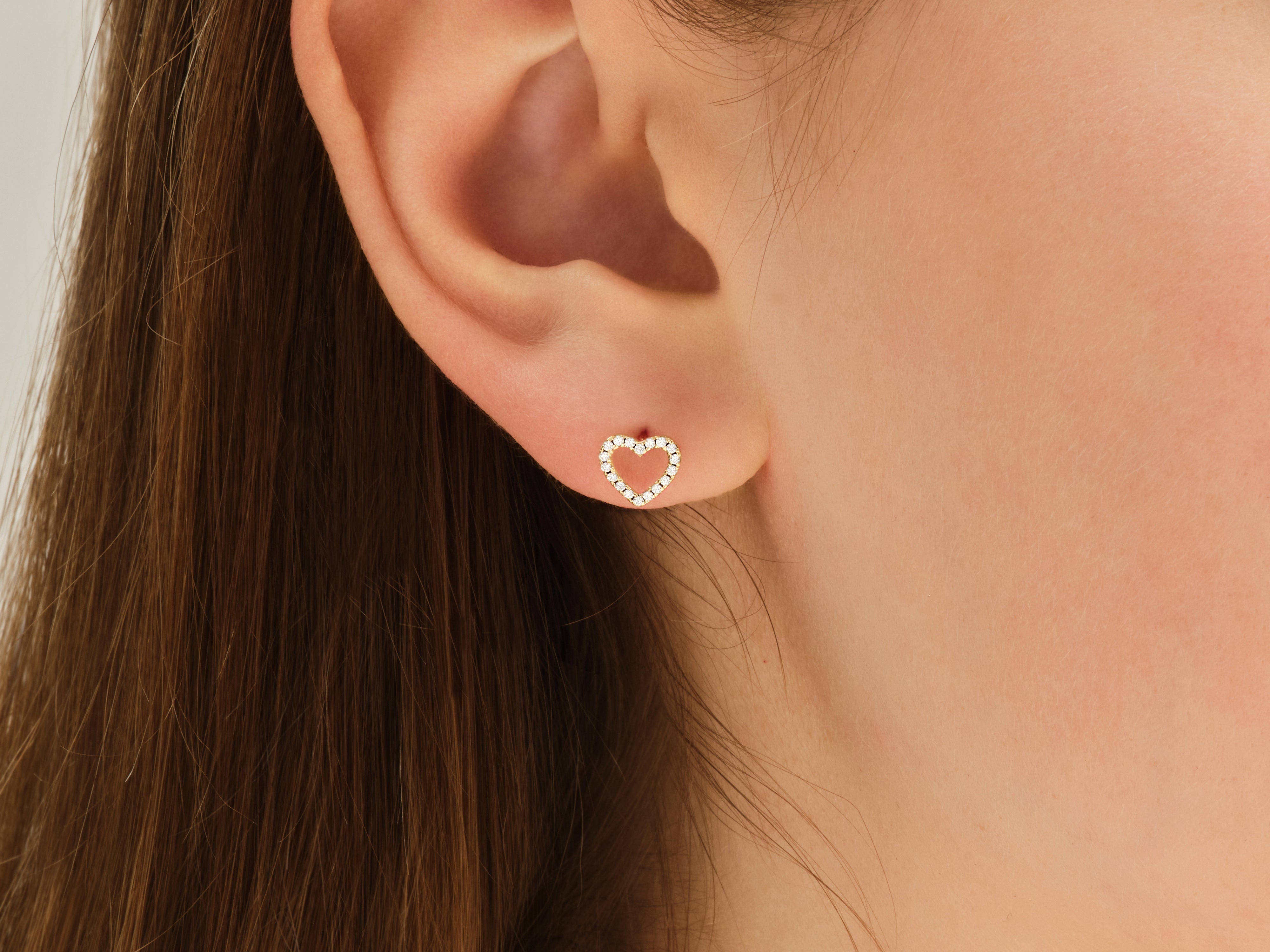 Diamond heart stud earring on ear, jewelry