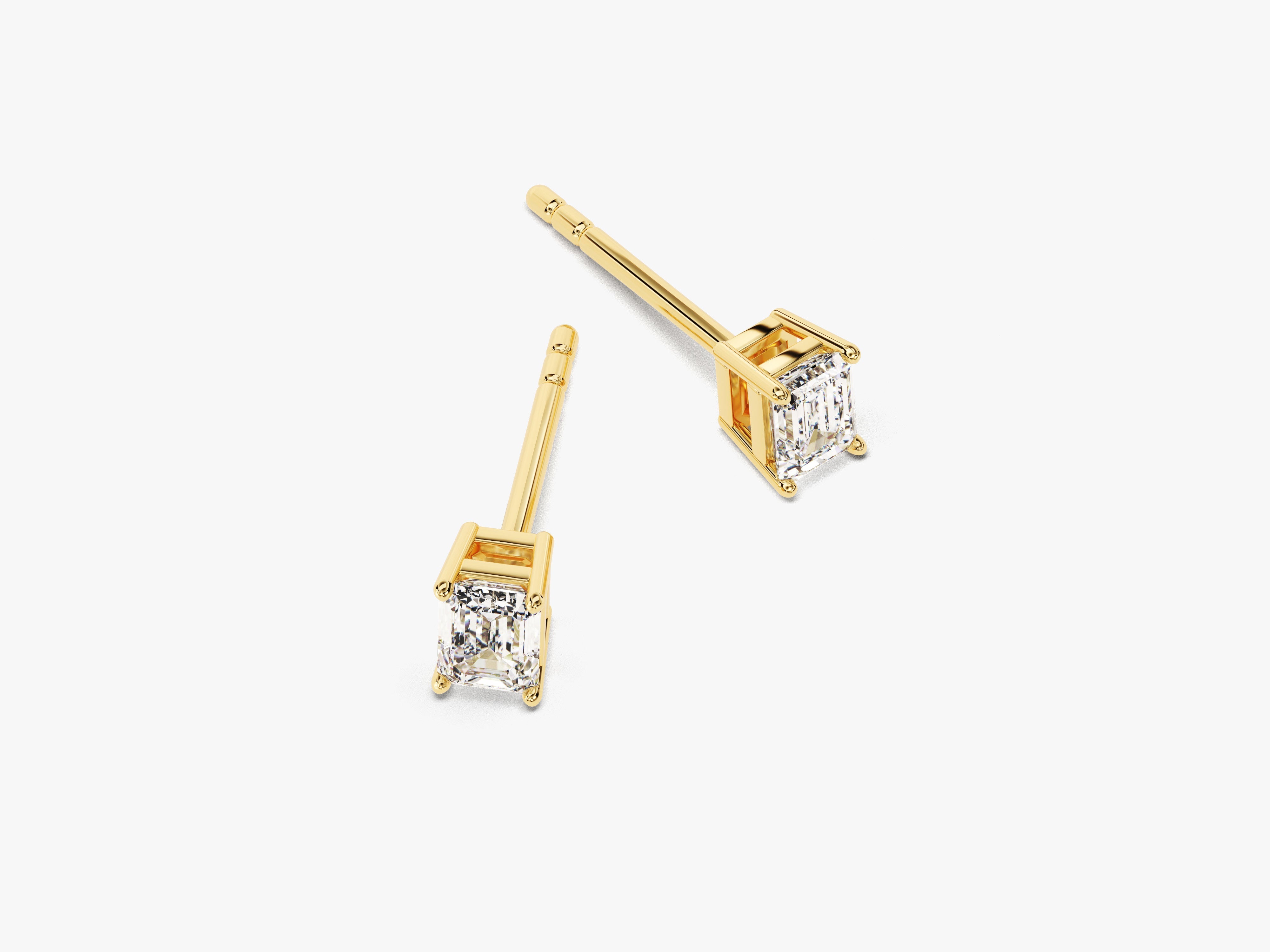 Emerald cut diamond stud earrings in yellow gold