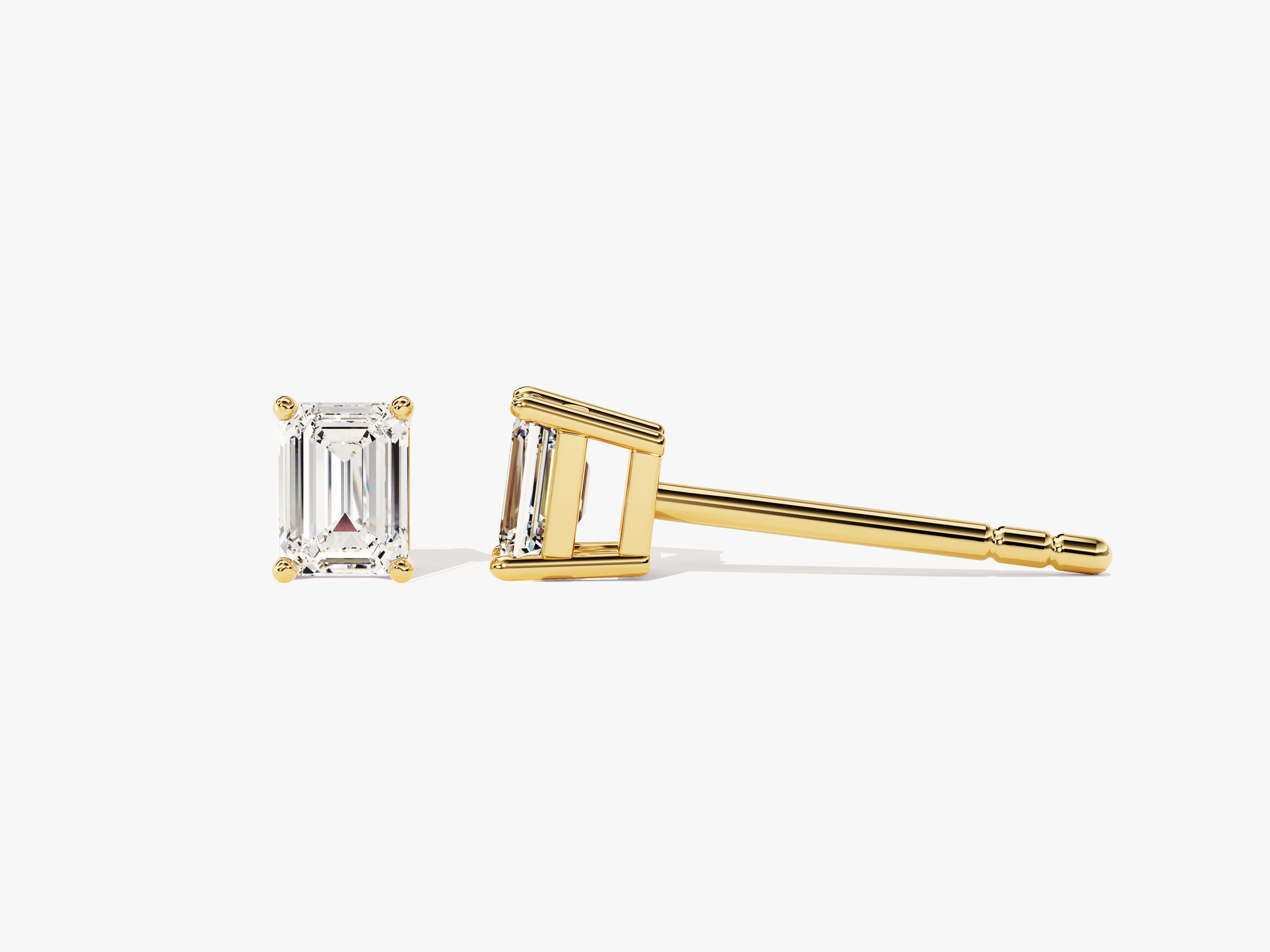 Emerald cut diamond stud earrings in yellow gold