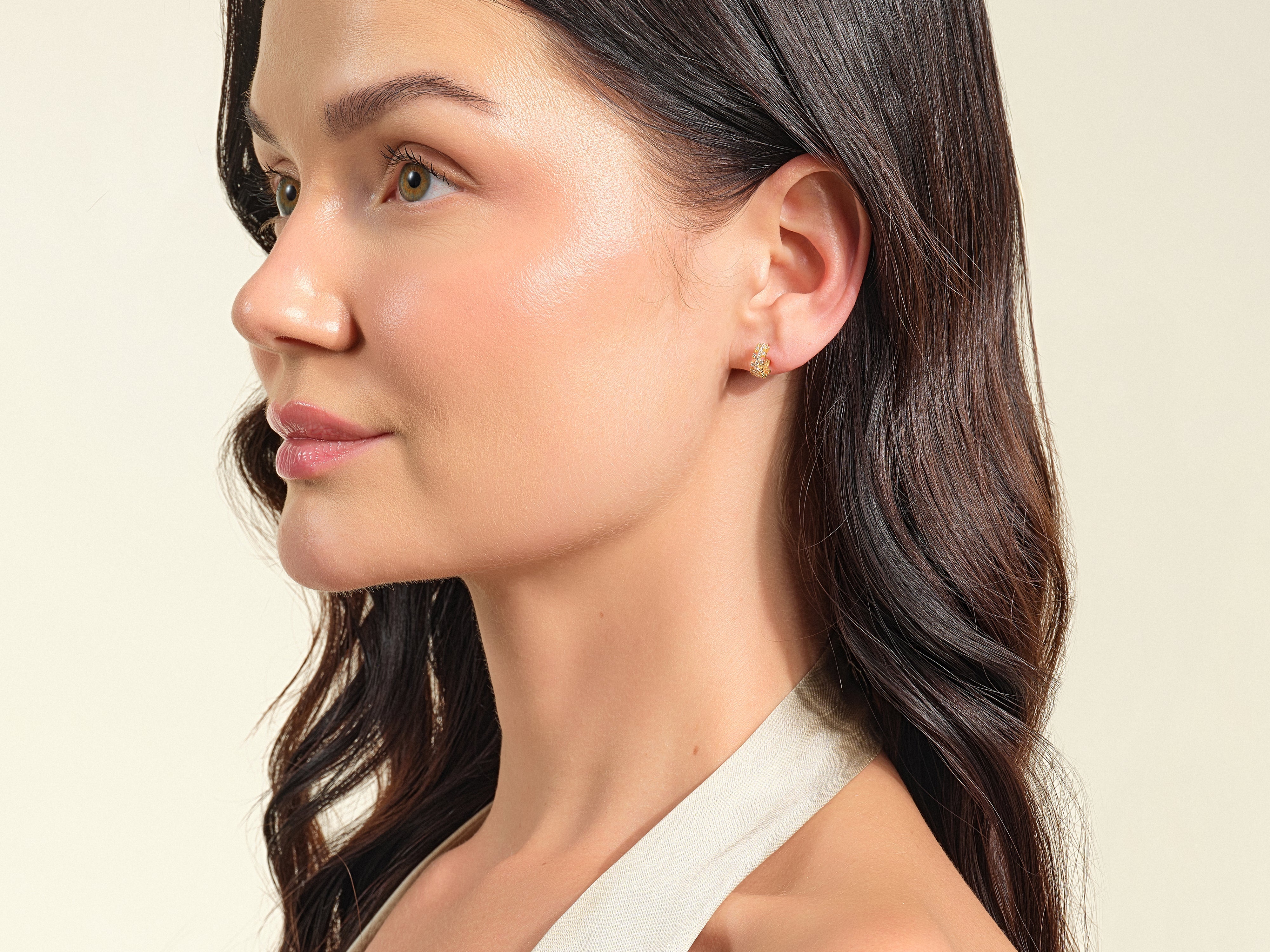 Diamond hoop earrings on a woman's ear, jewelry photography