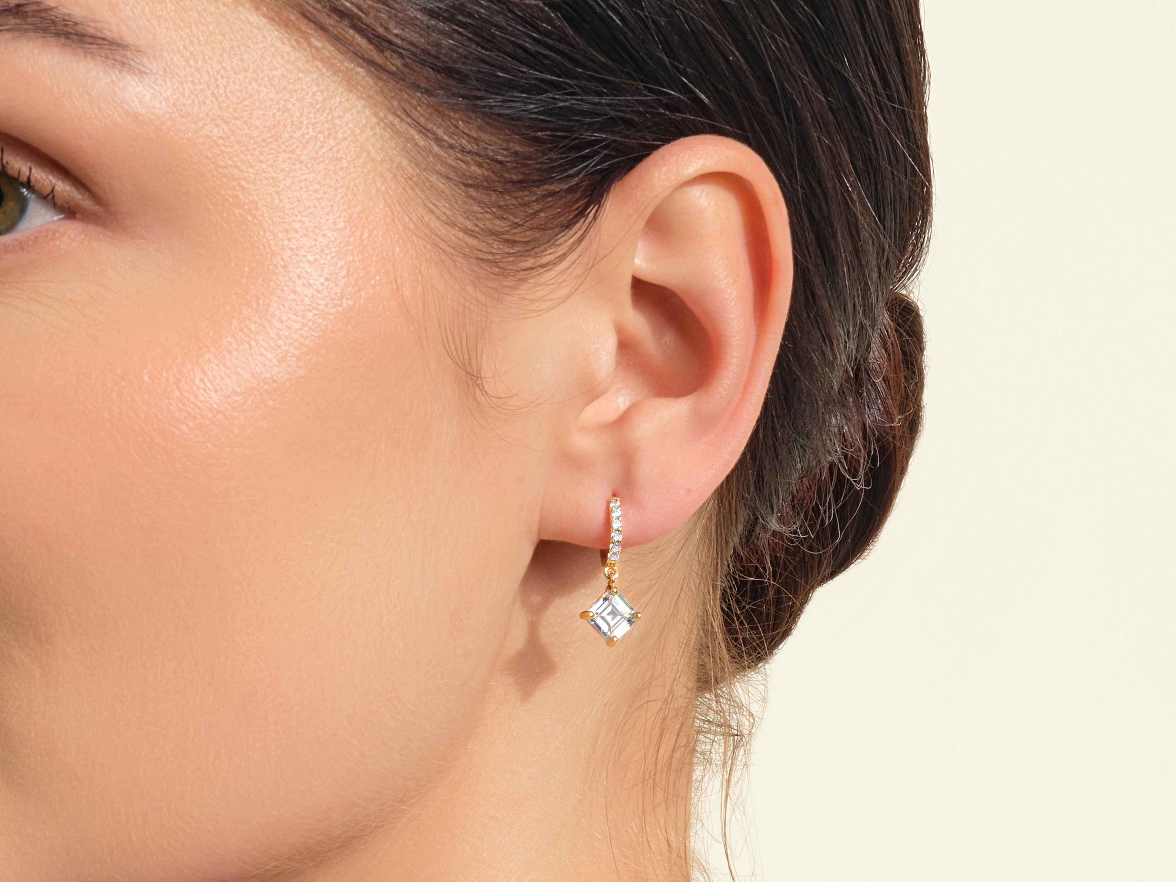 Diamond drop earrings on model's ear, jewelry photography