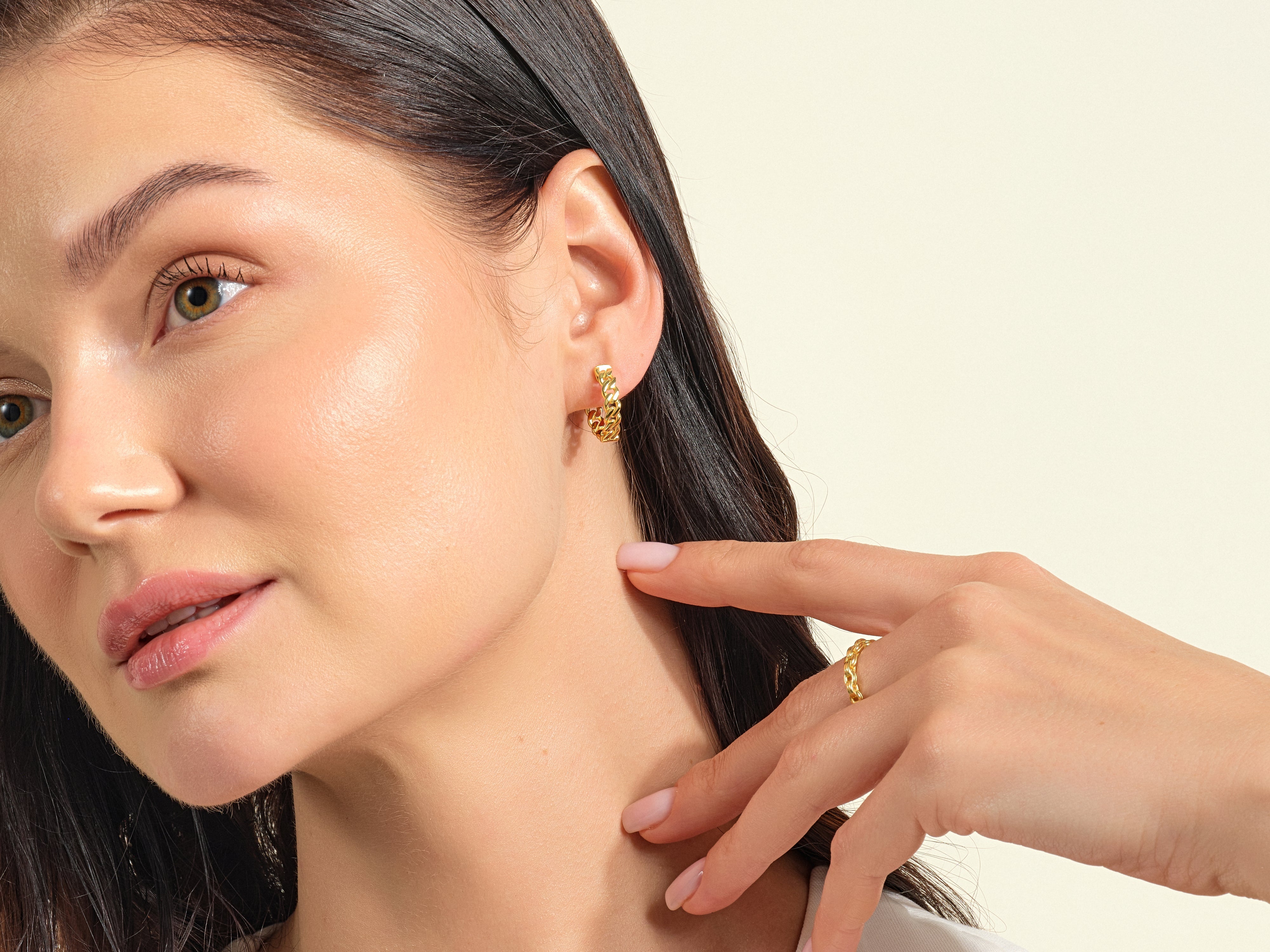 Gold chain earrings and ring on model, jewelry photography