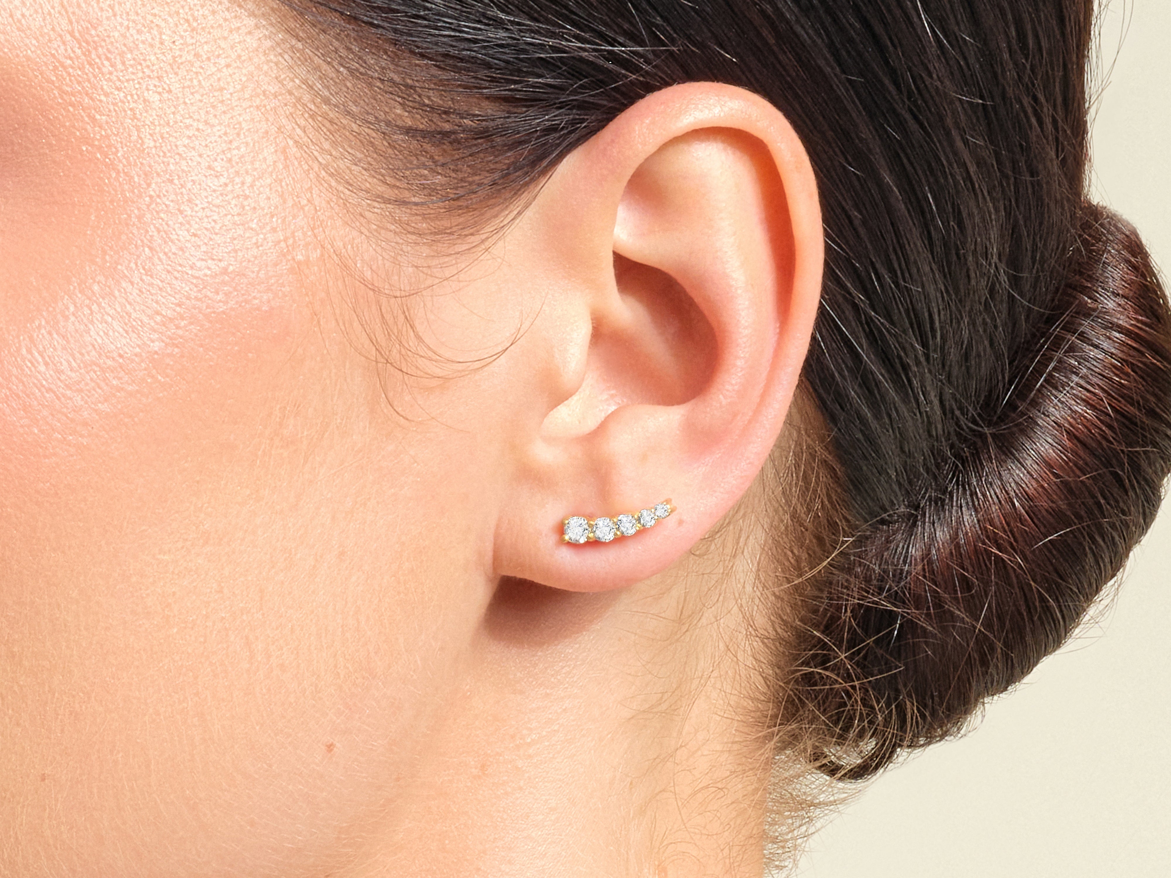 Diamond ear climber jewelry on a woman's ear