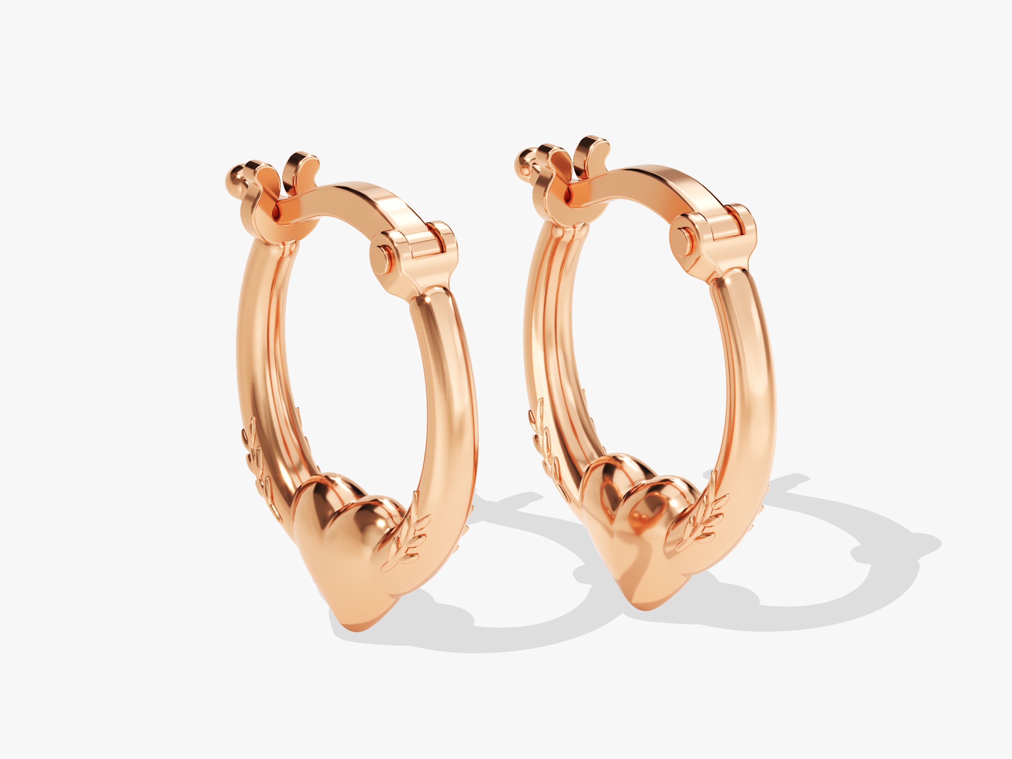 Rose gold heart hoop earrings with delicate leaf detail