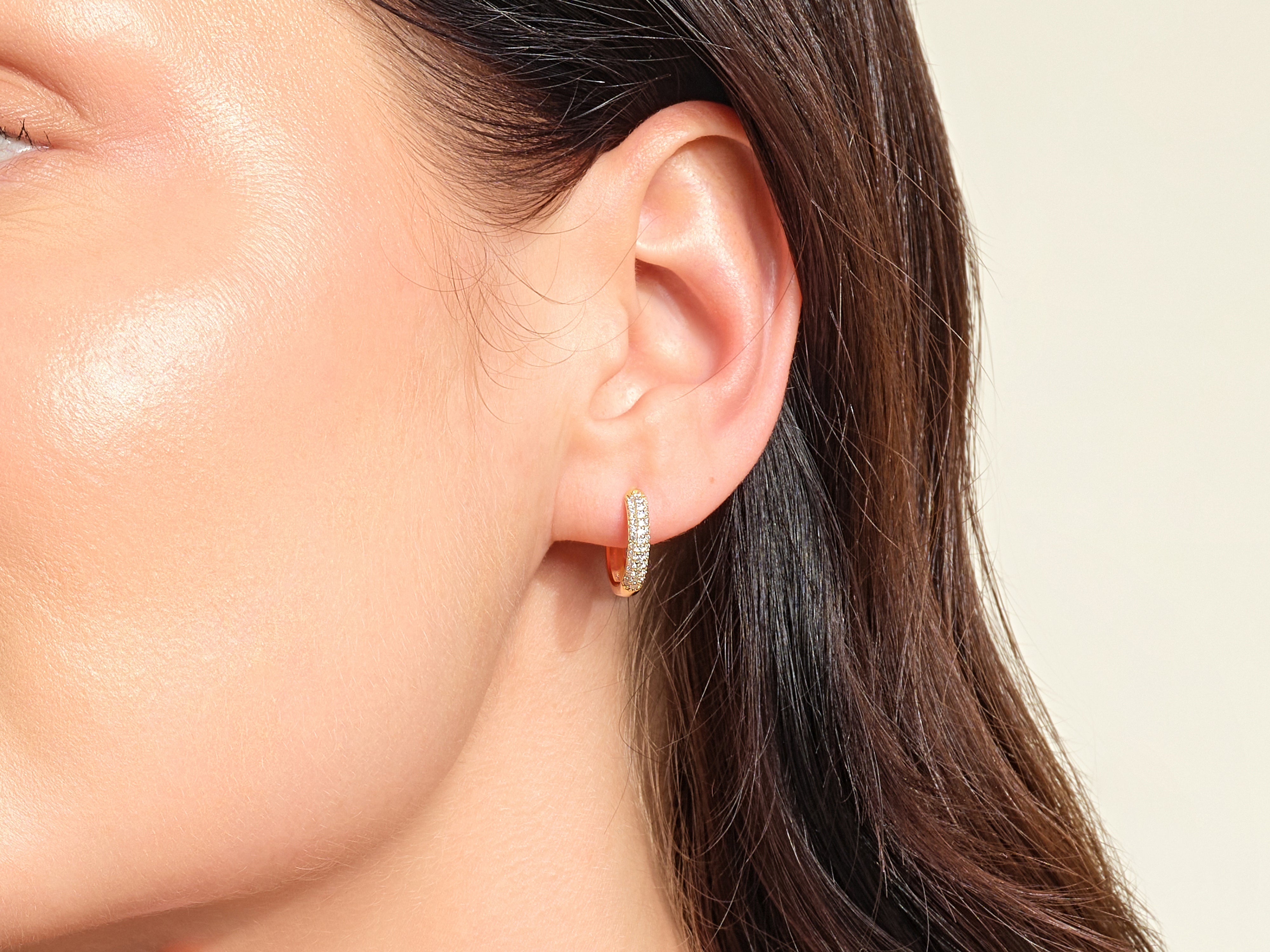 Diamond hoop earrings on a woman's ear, jewelry photography