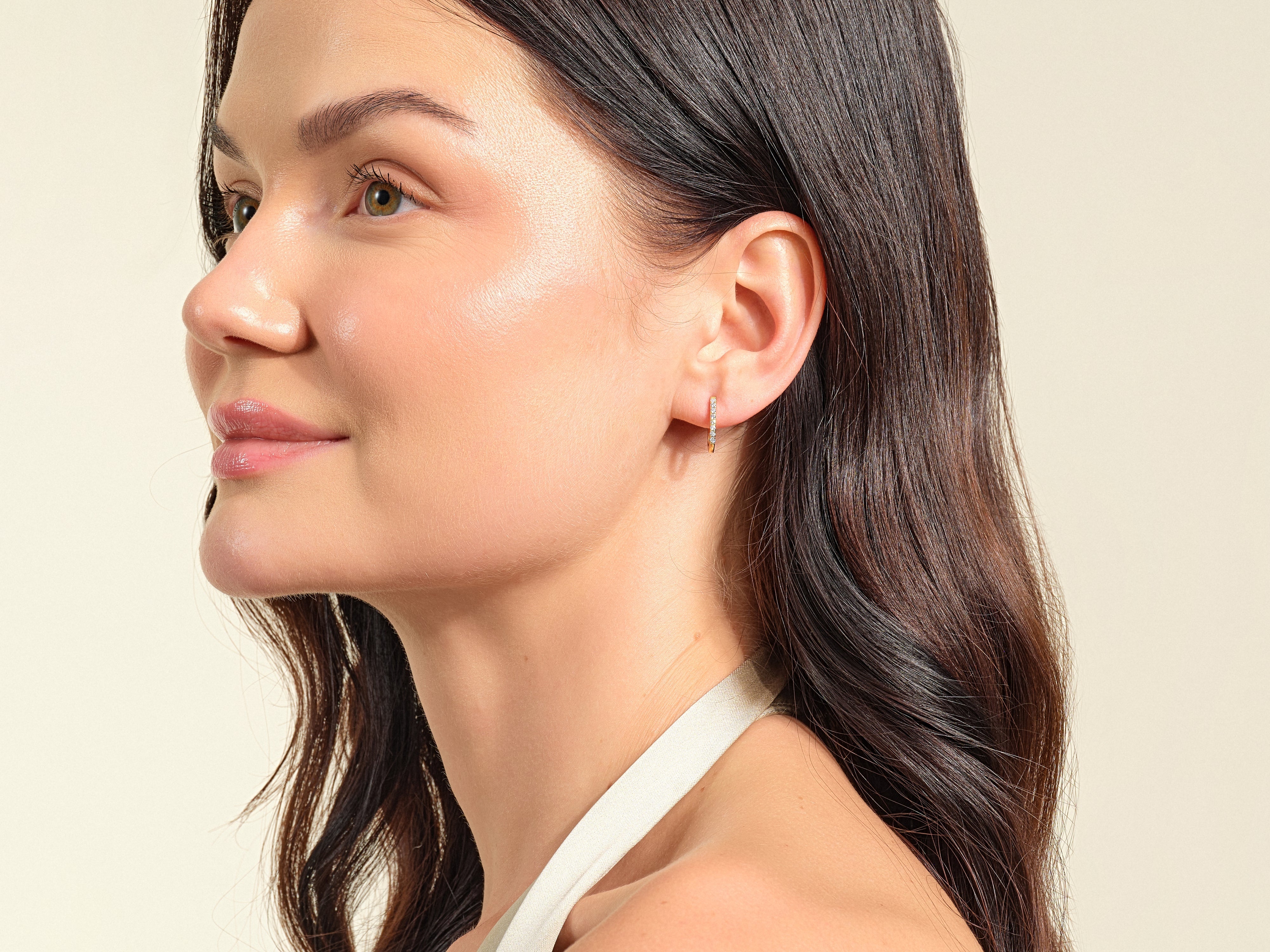 Diamond hoop earrings on a woman's ear, jewelry photography