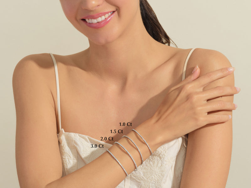 Diamond tennis bracelets in various carat weights on a woman's wrist