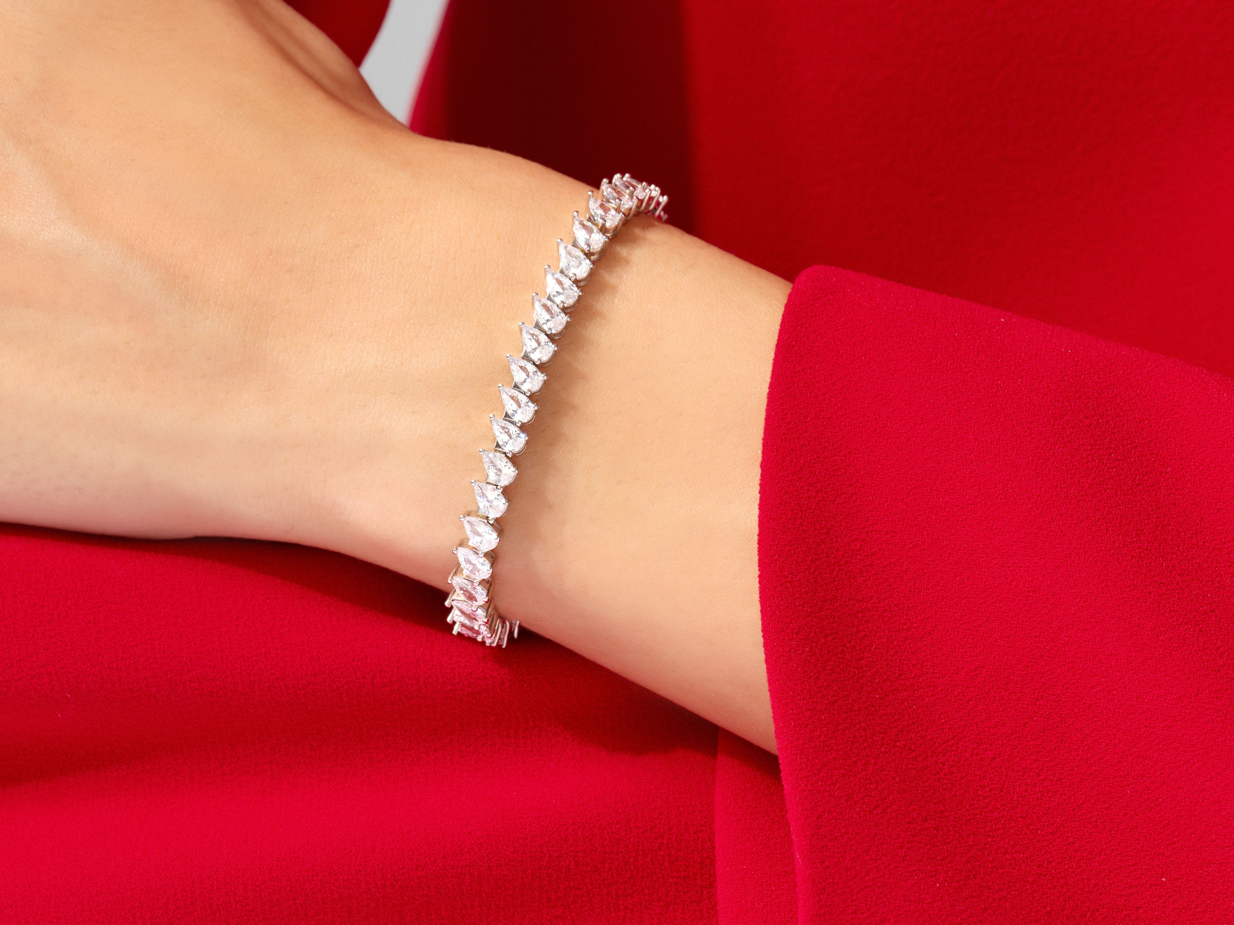 Diamond tennis bracelet on a red background, jewelry