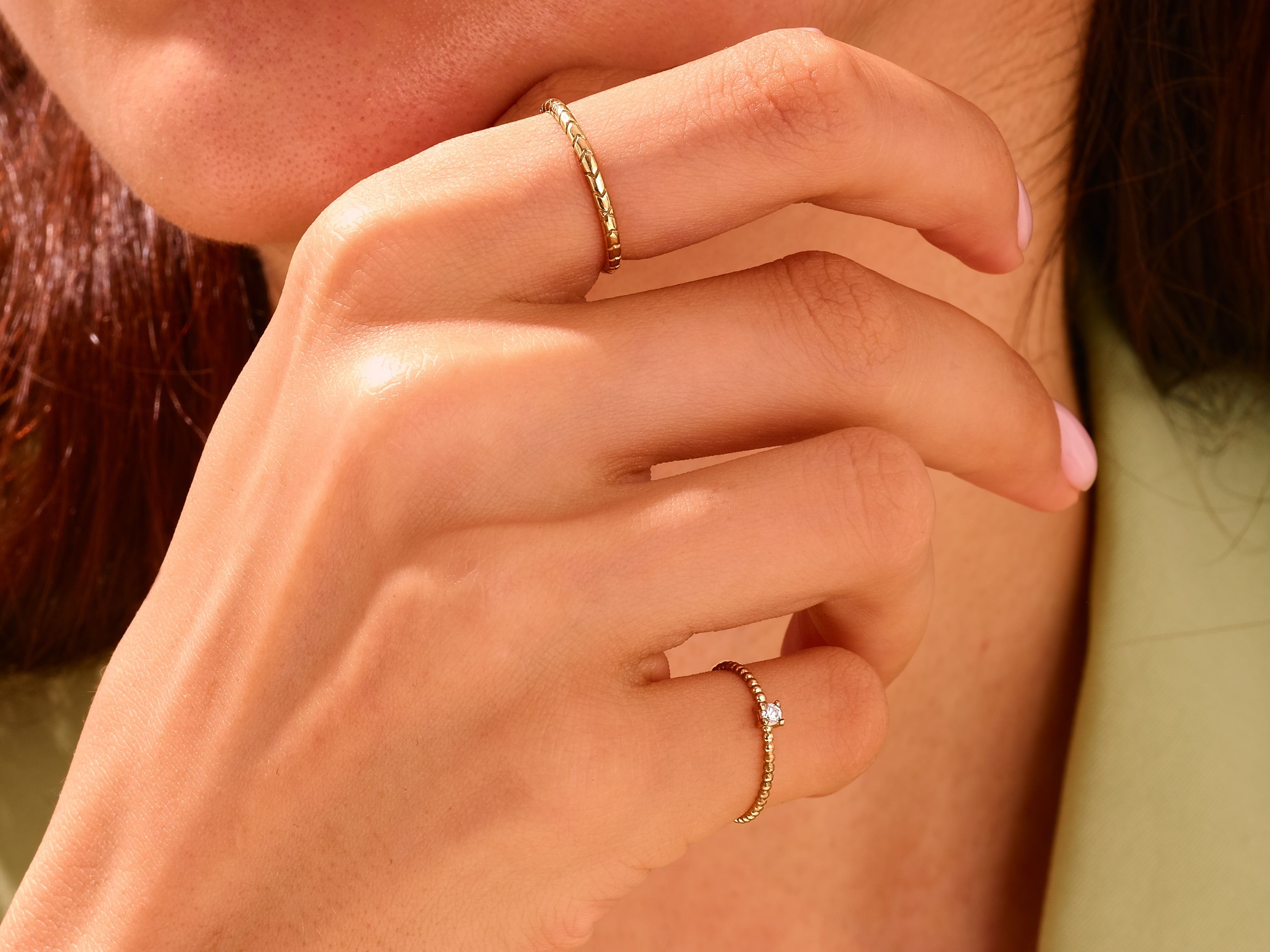Elegant gold rings with diamonds on a woman's hand
