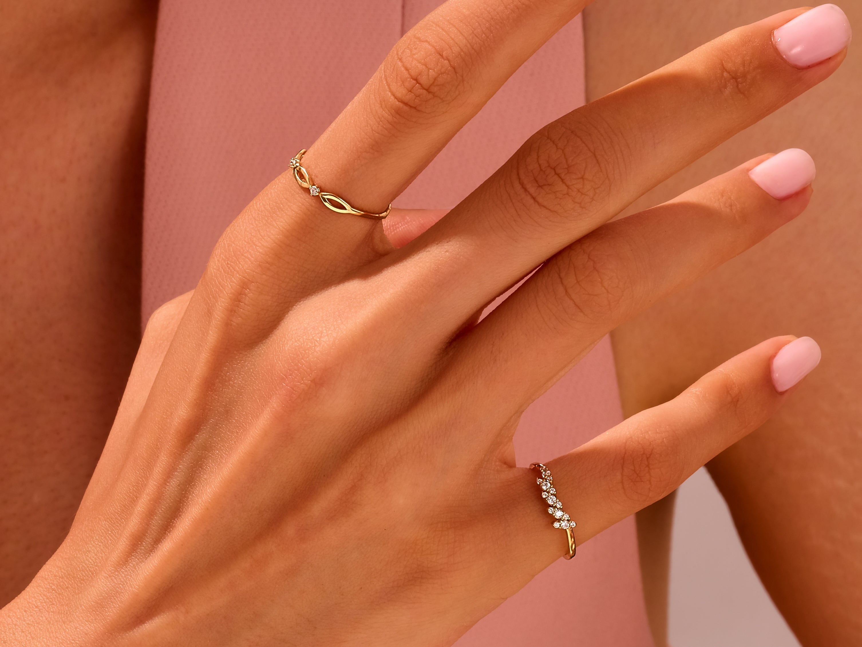 Delicate gold diamond rings on a hand, jewelry