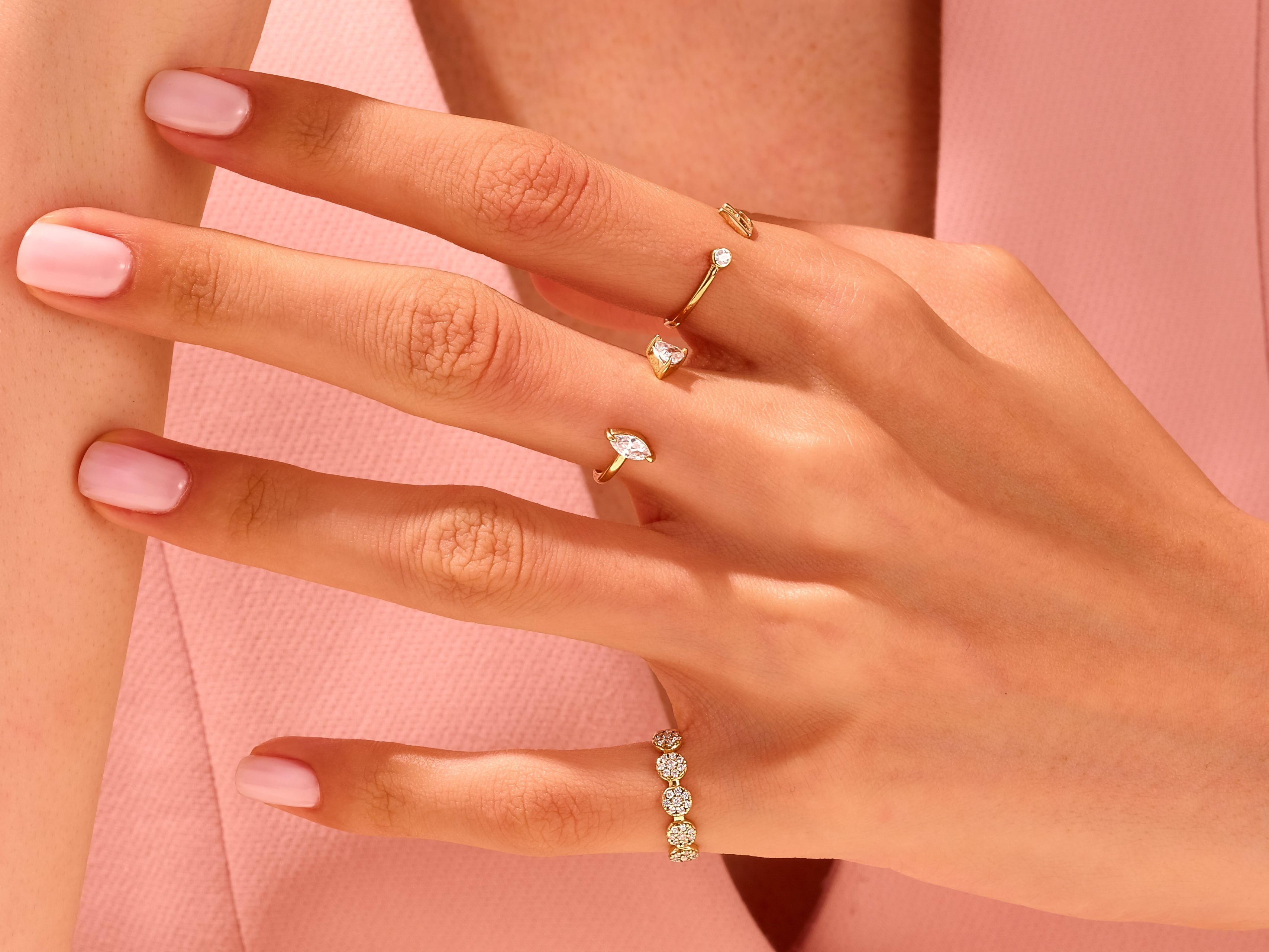 Gold rings with diamonds on a hand, jewelry photography