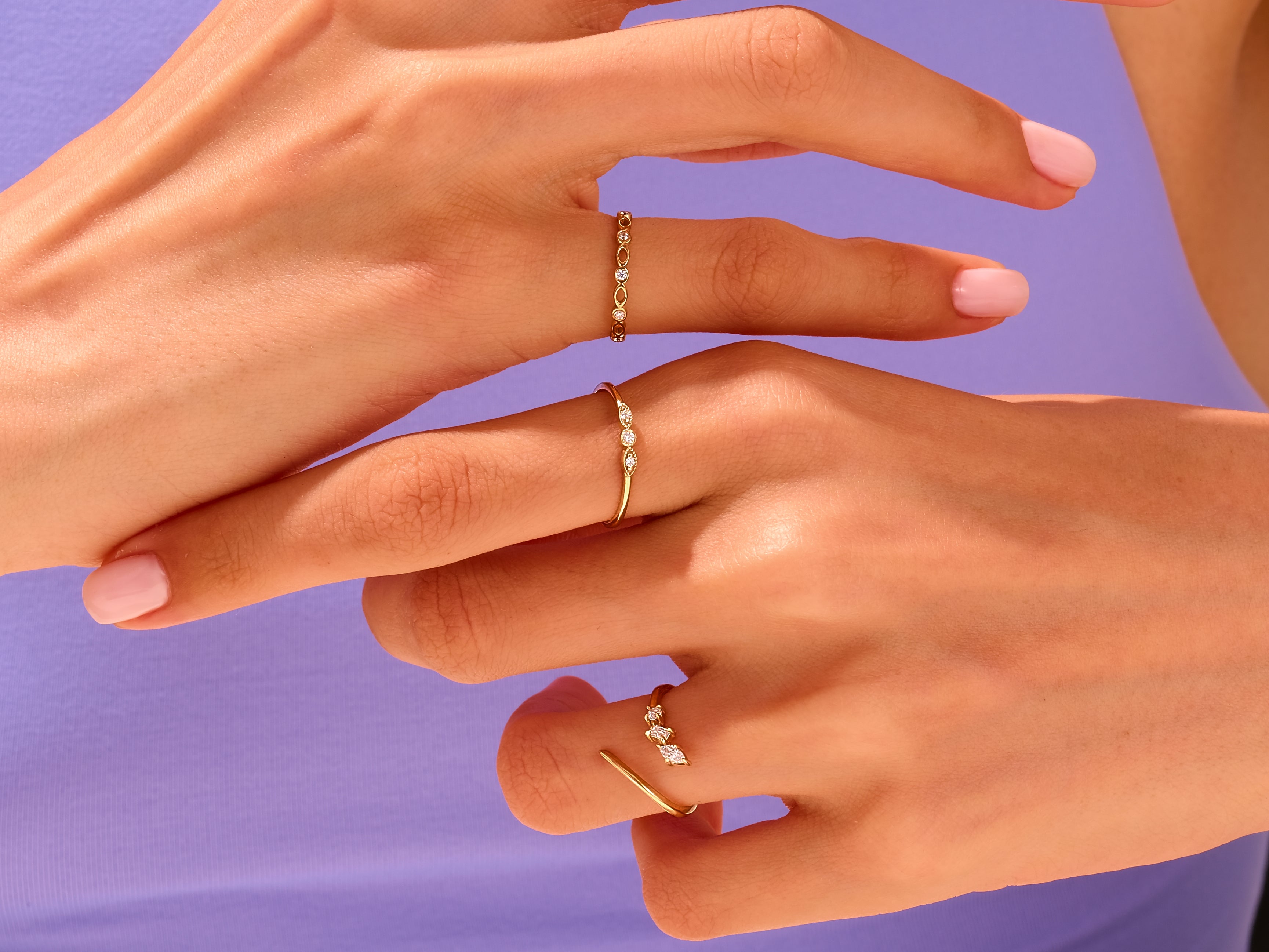 Delicate gold diamond rings on hands, jewelry photography