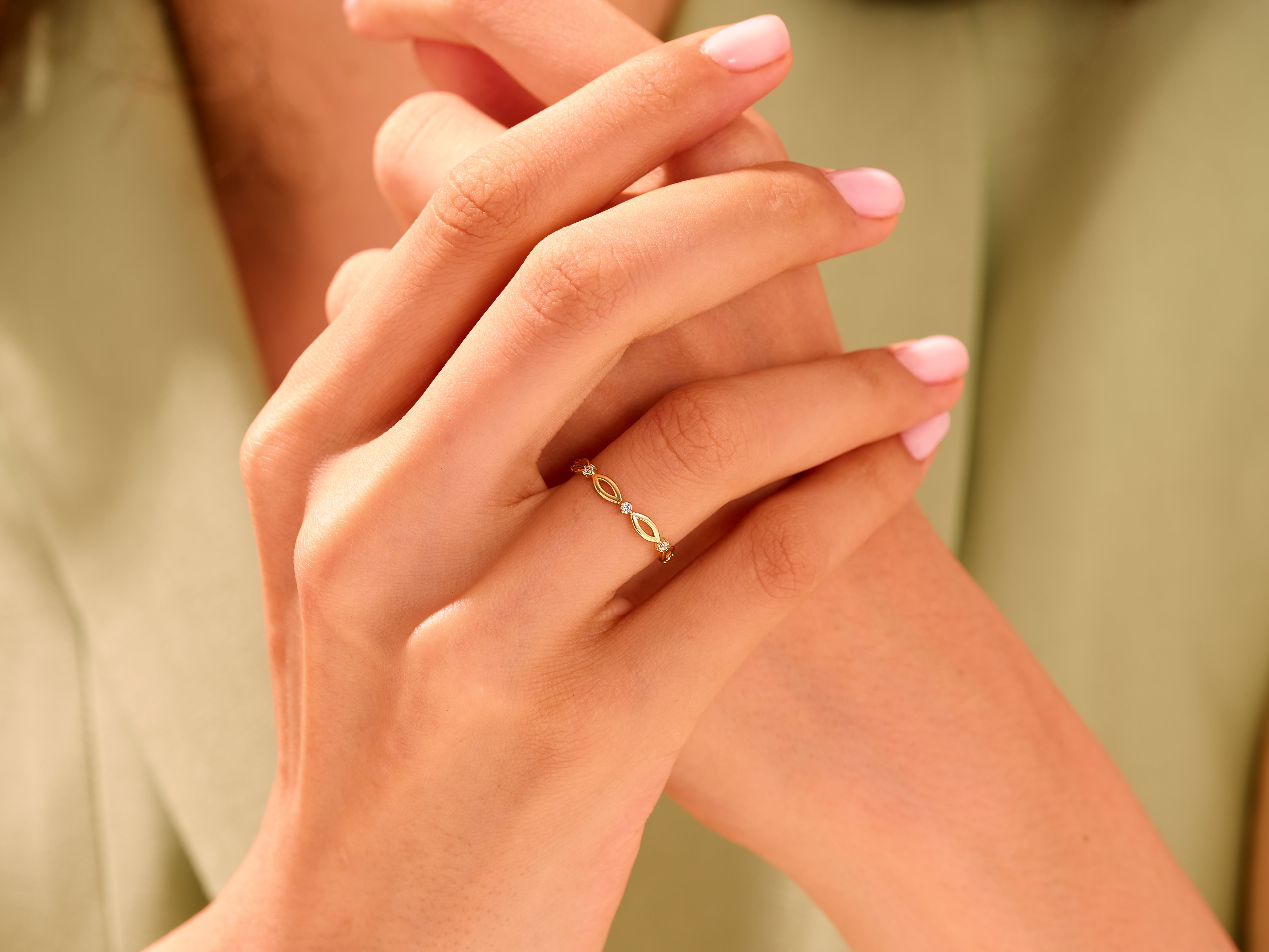 Delicate gold ring with diamonds on a woman's hand