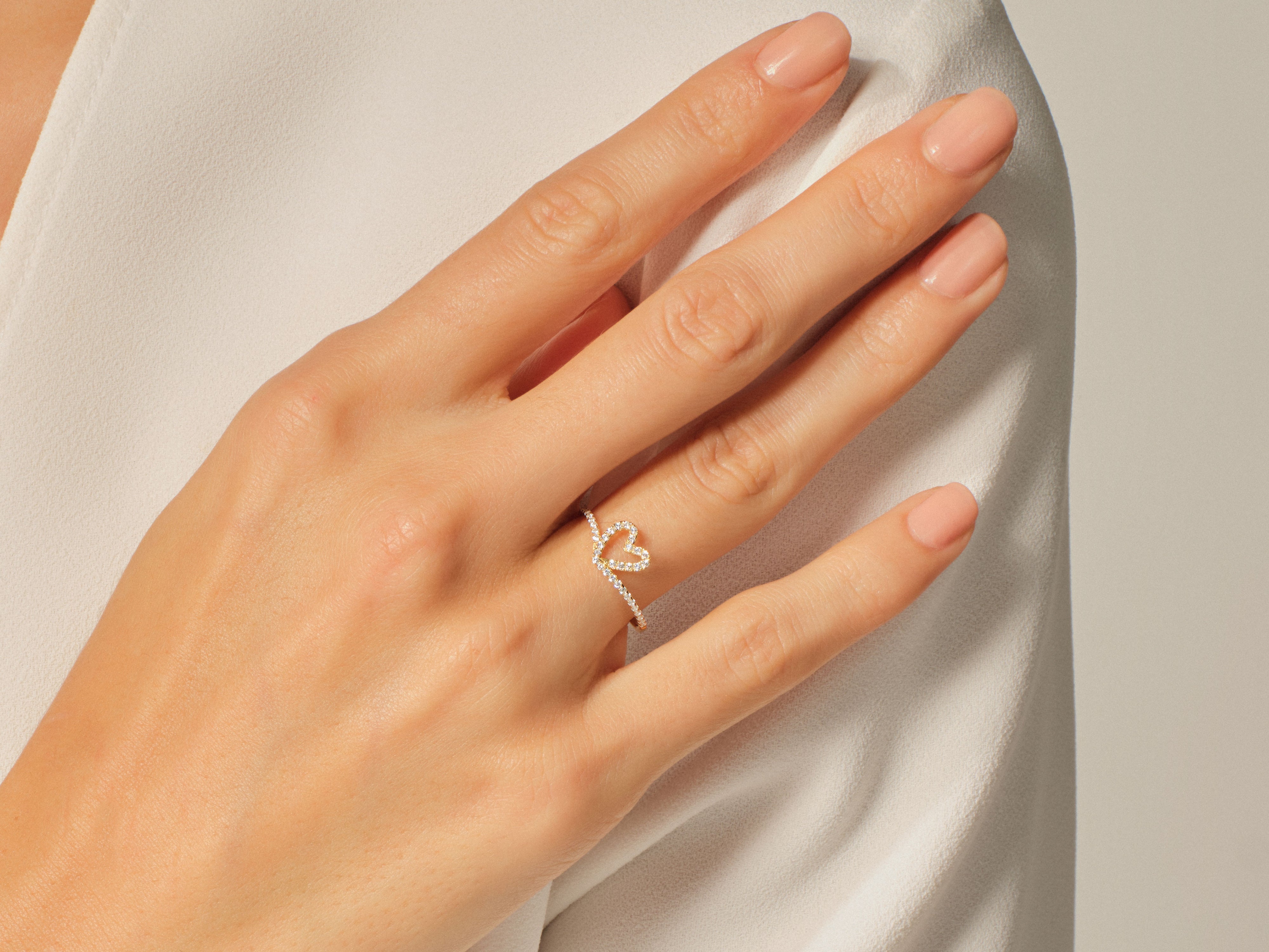 Diamond heart ring on a woman's hand