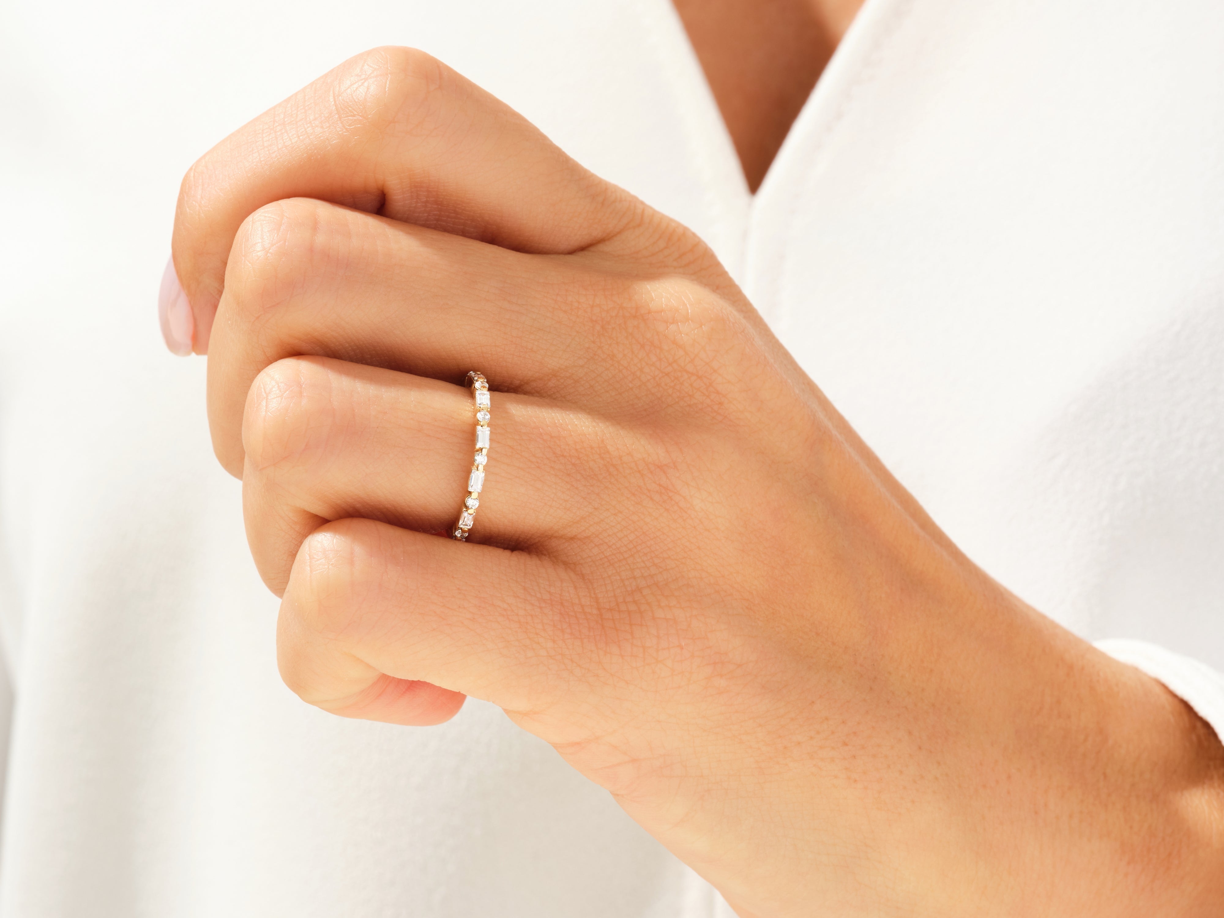 Diamond eternity band on a hand, fine jewelry for women