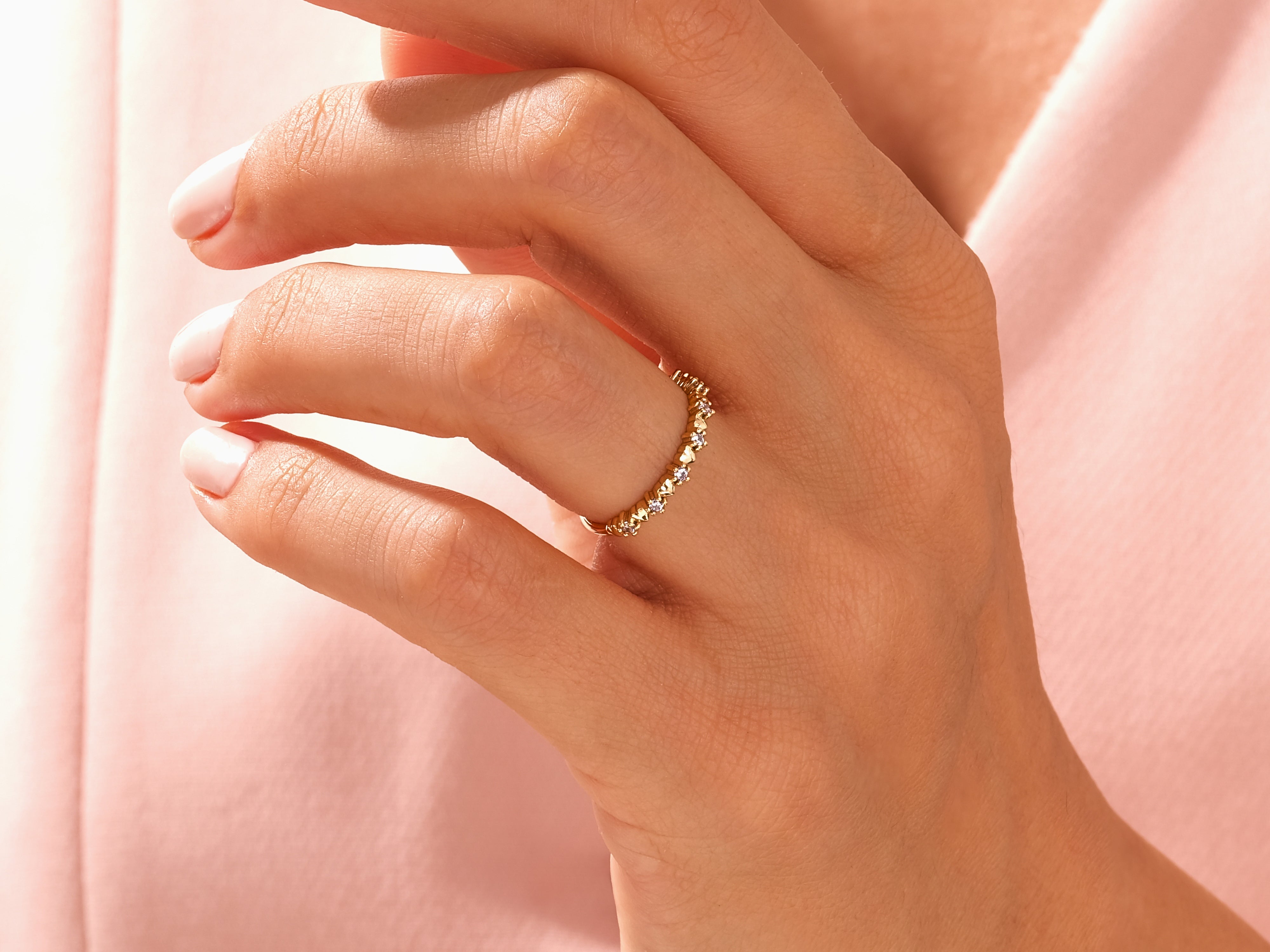 Delicate gold ring with diamonds on a woman's finger