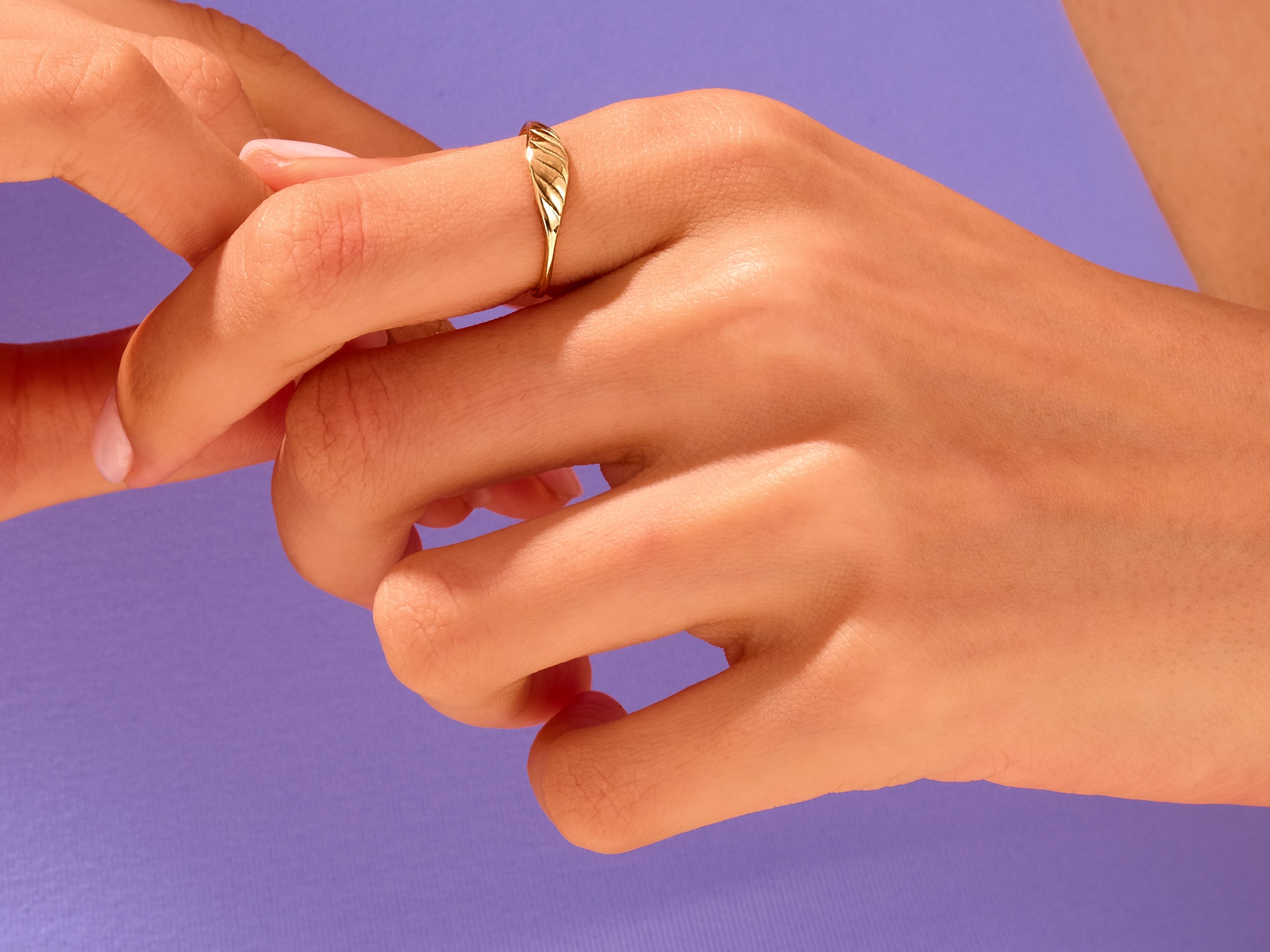 Gold leaf ring on a finger, jewelry photography