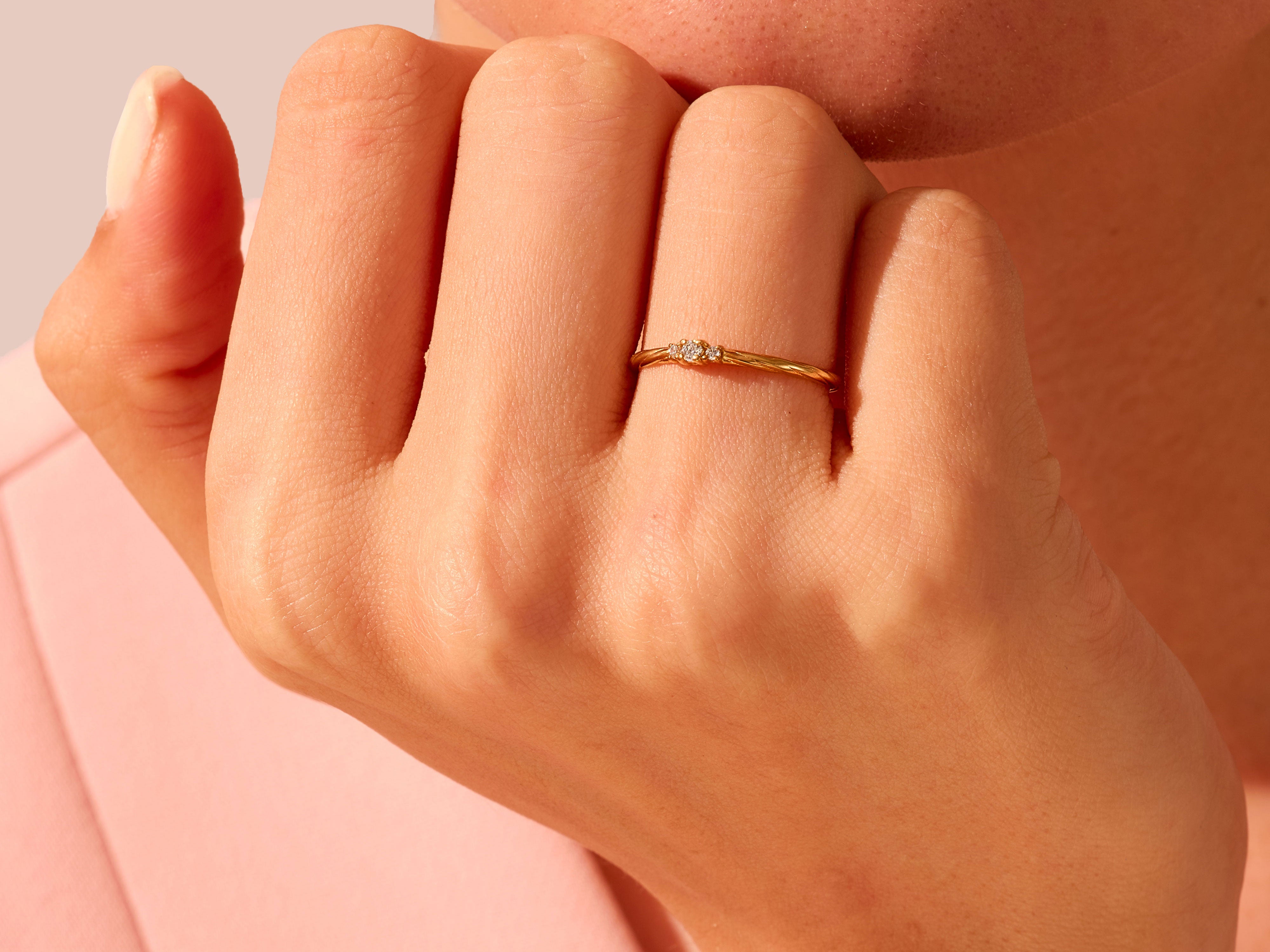 Gold ring with diamonds on a hand, jewelry product