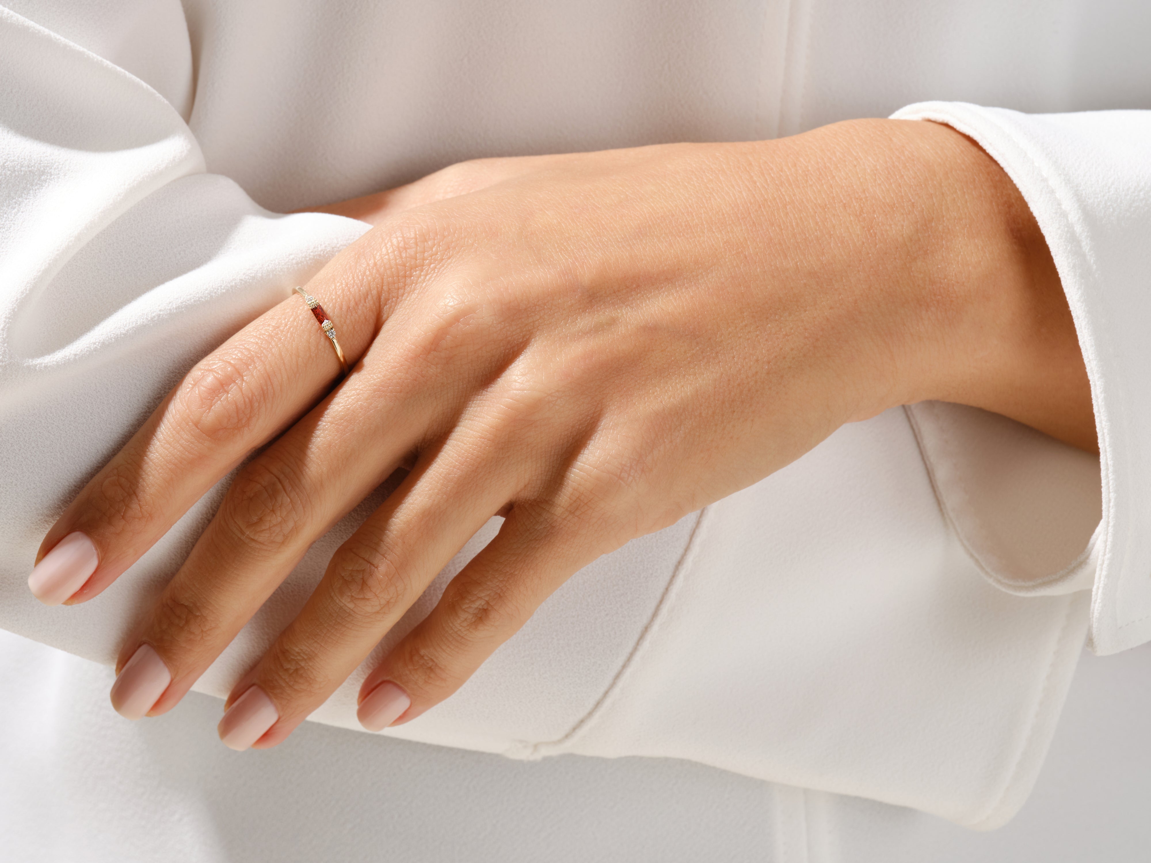 Gold ring with ruby and diamonds on a woman's hand