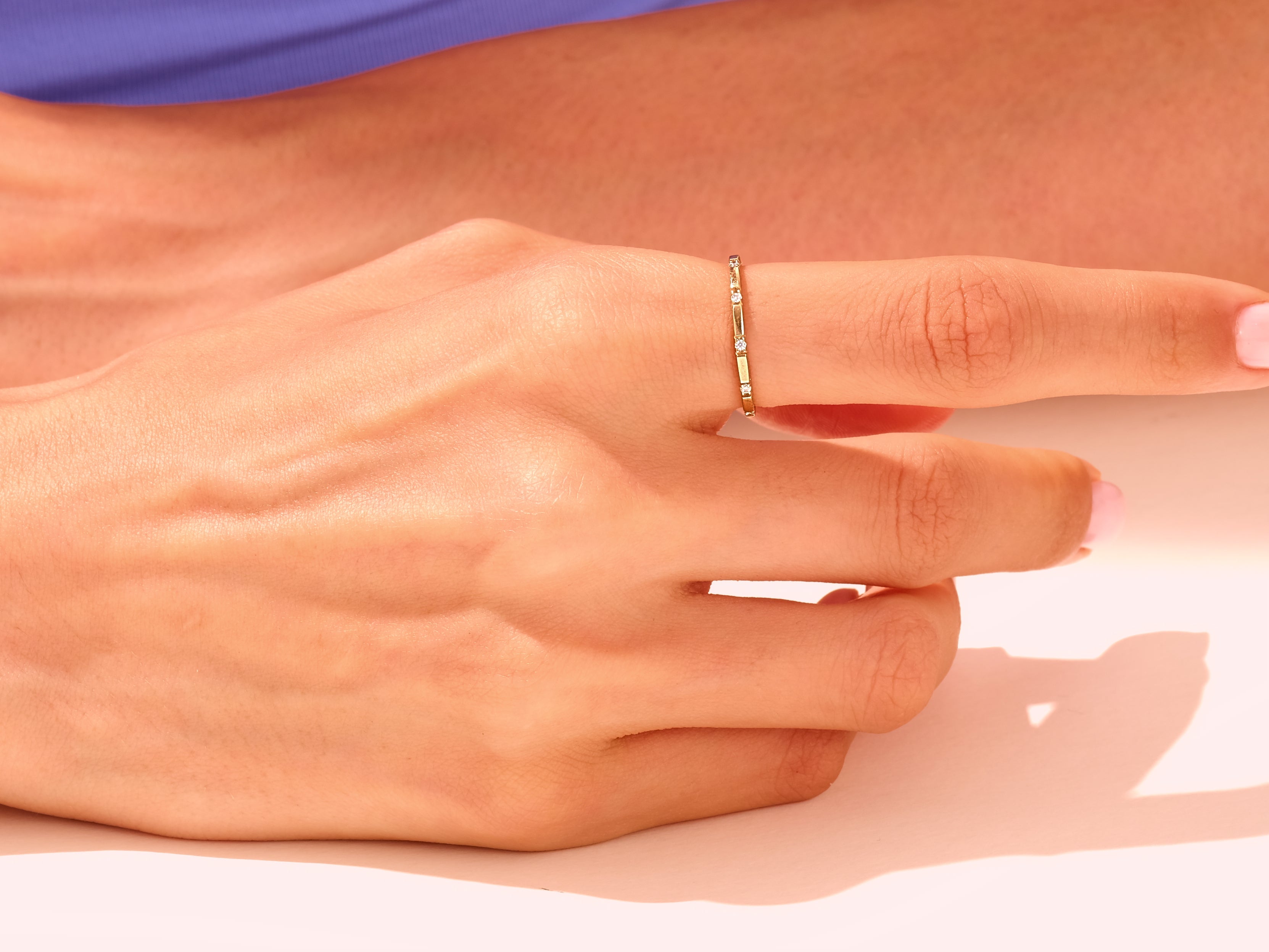 Delicate gold ring with diamonds on a woman's finger