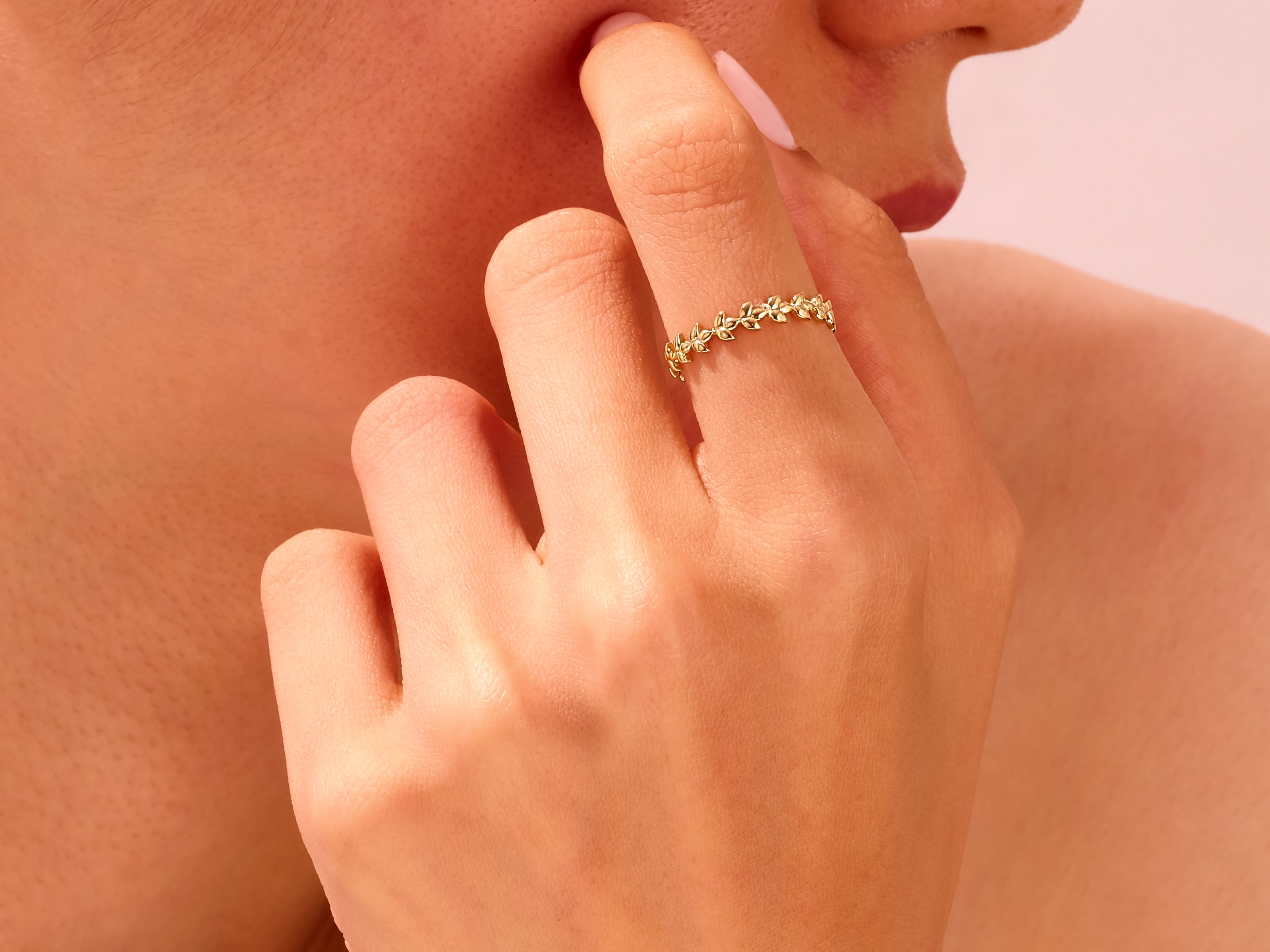Delicate gold leaf ring on a woman's finger, jewelry