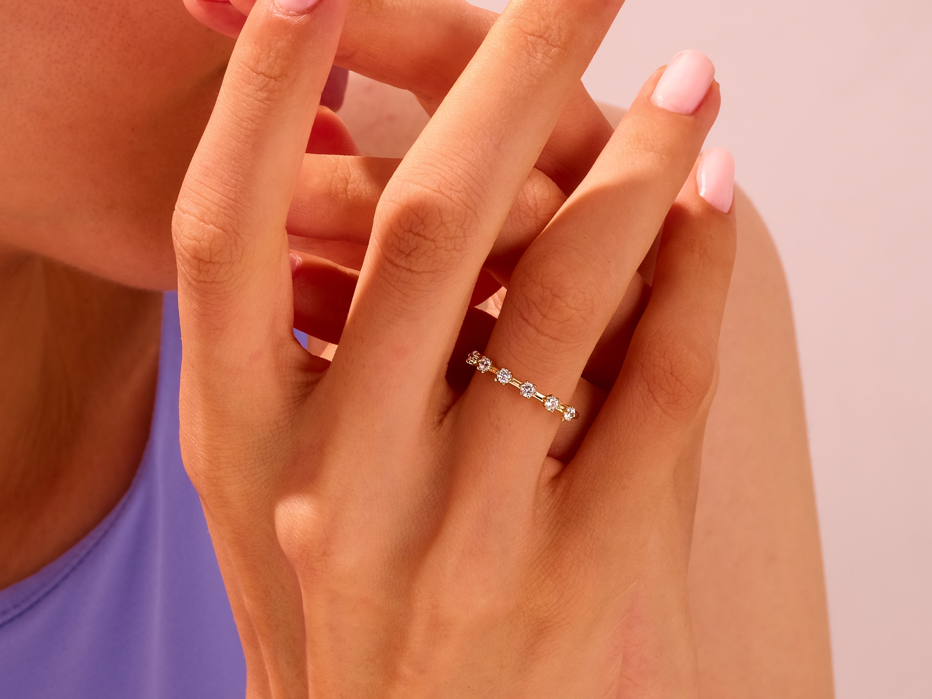 Gold diamond band ring on a woman's finger