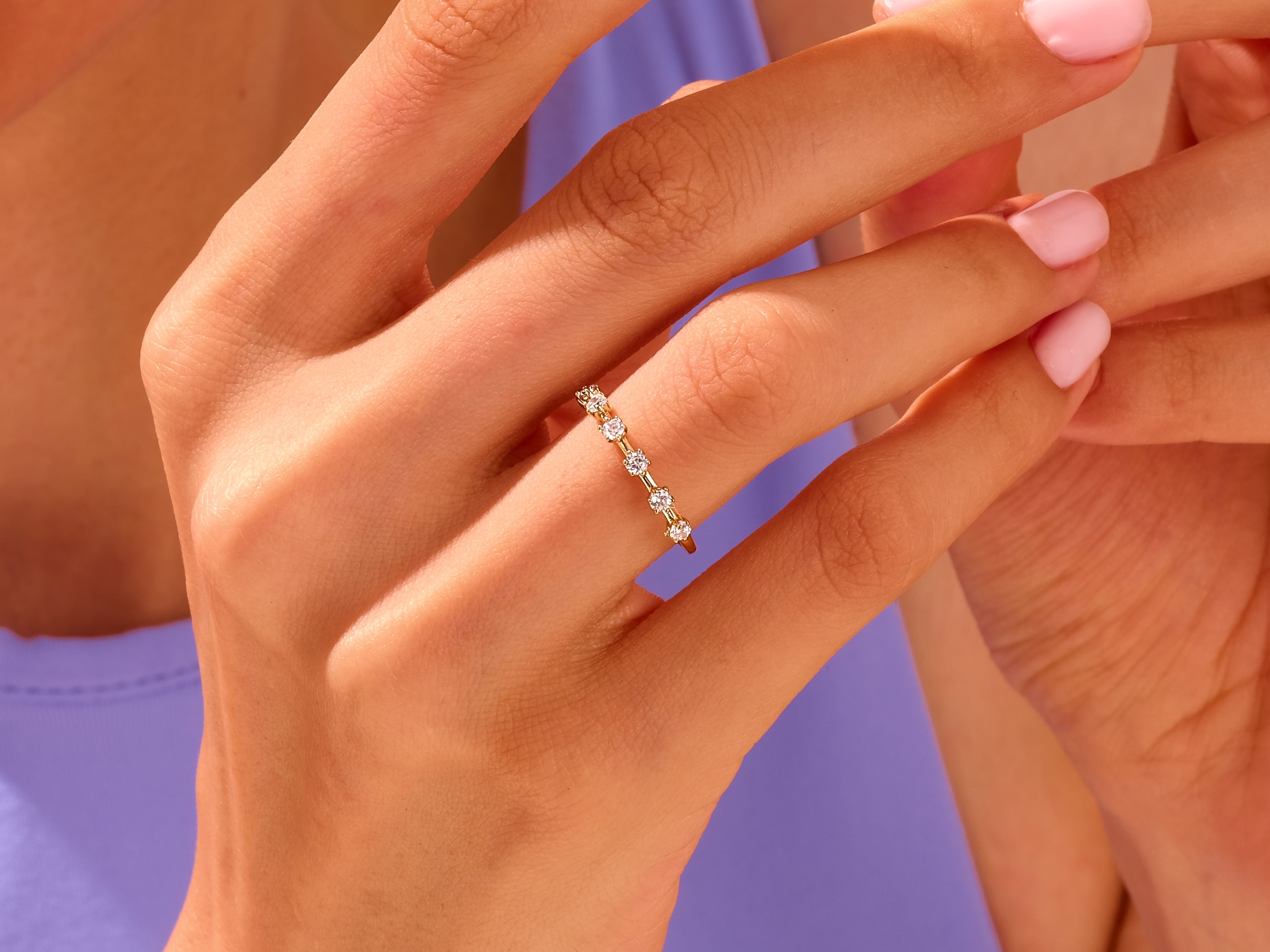 Diamond band ring on a woman's hand, fine jewelry