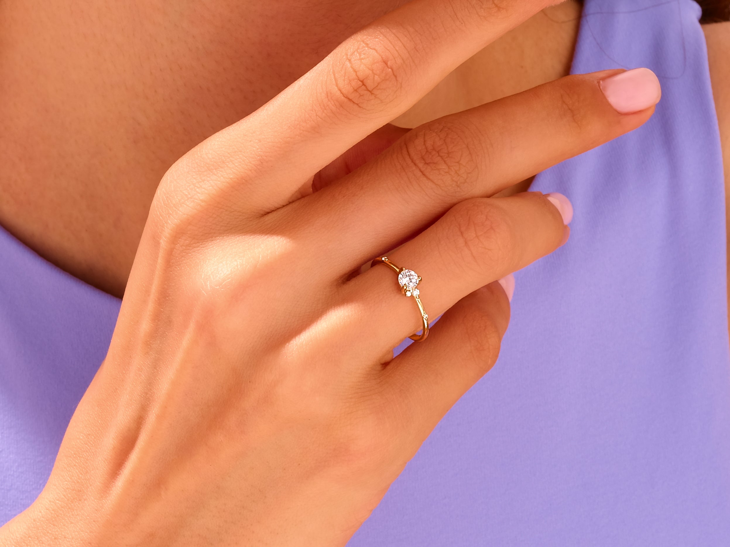 Gold ring with diamonds on a hand