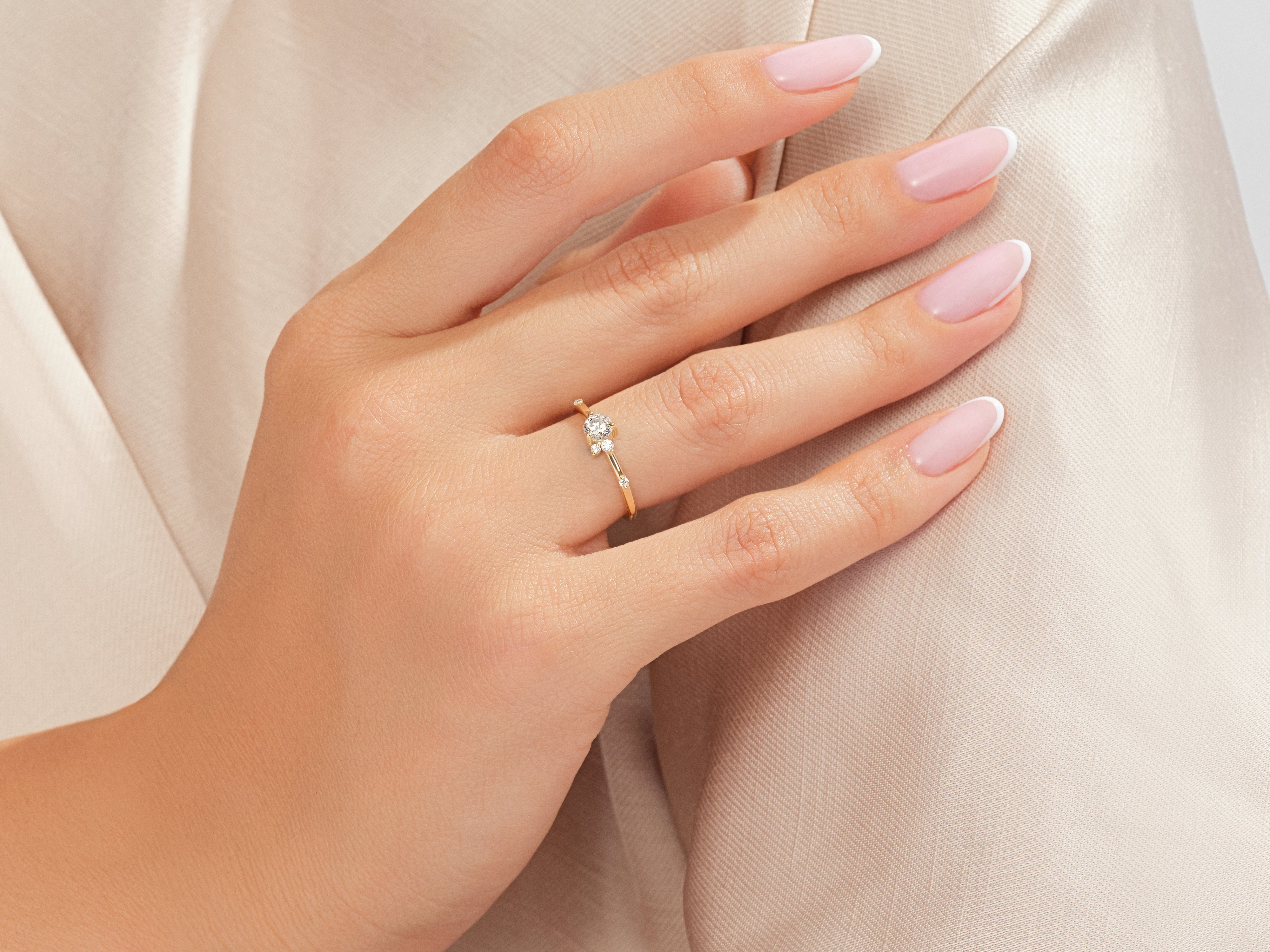 Delicate gold diamond ring on a woman's hand