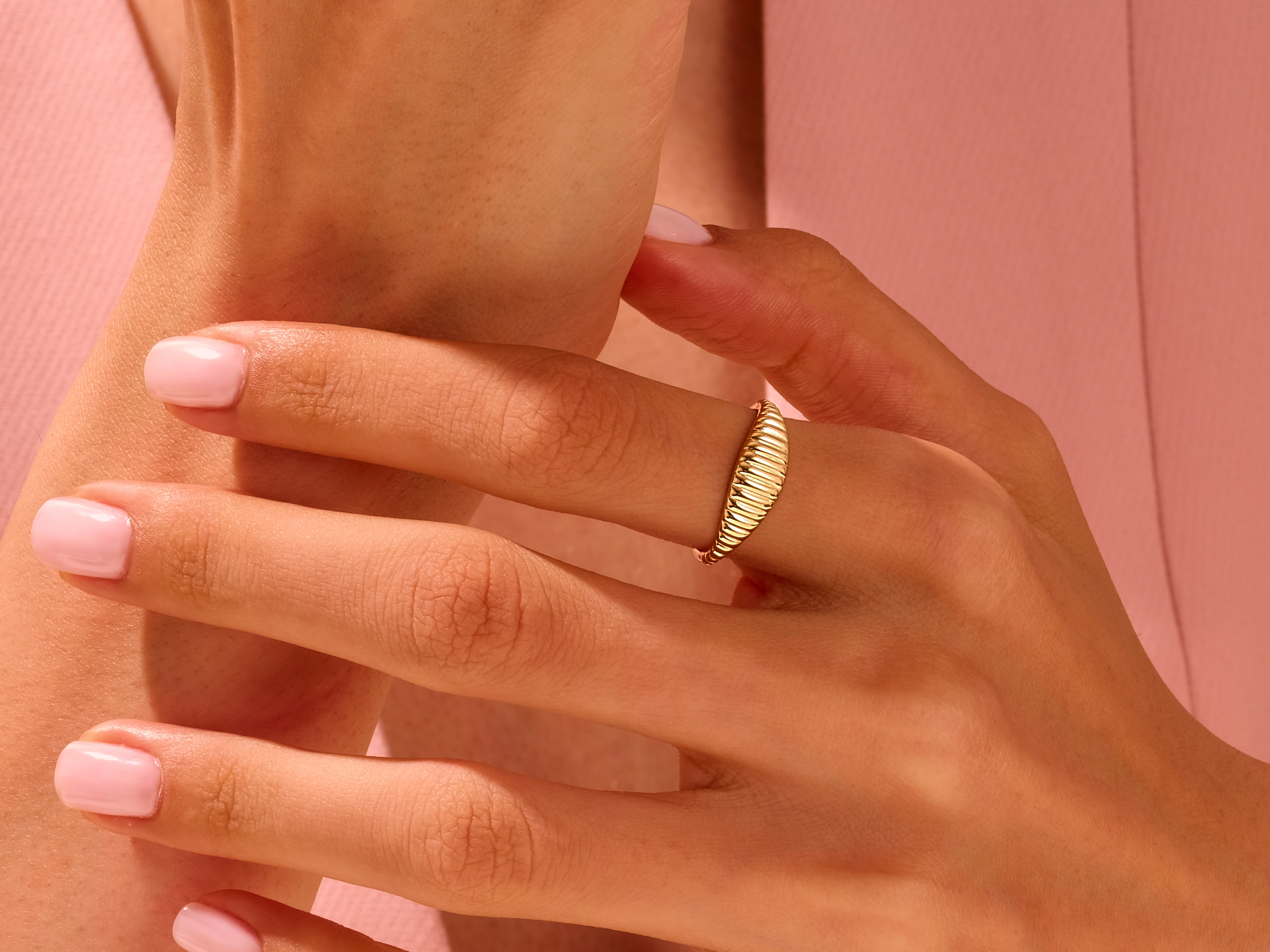 Gold ribbed ring on a hand, jewelry for women