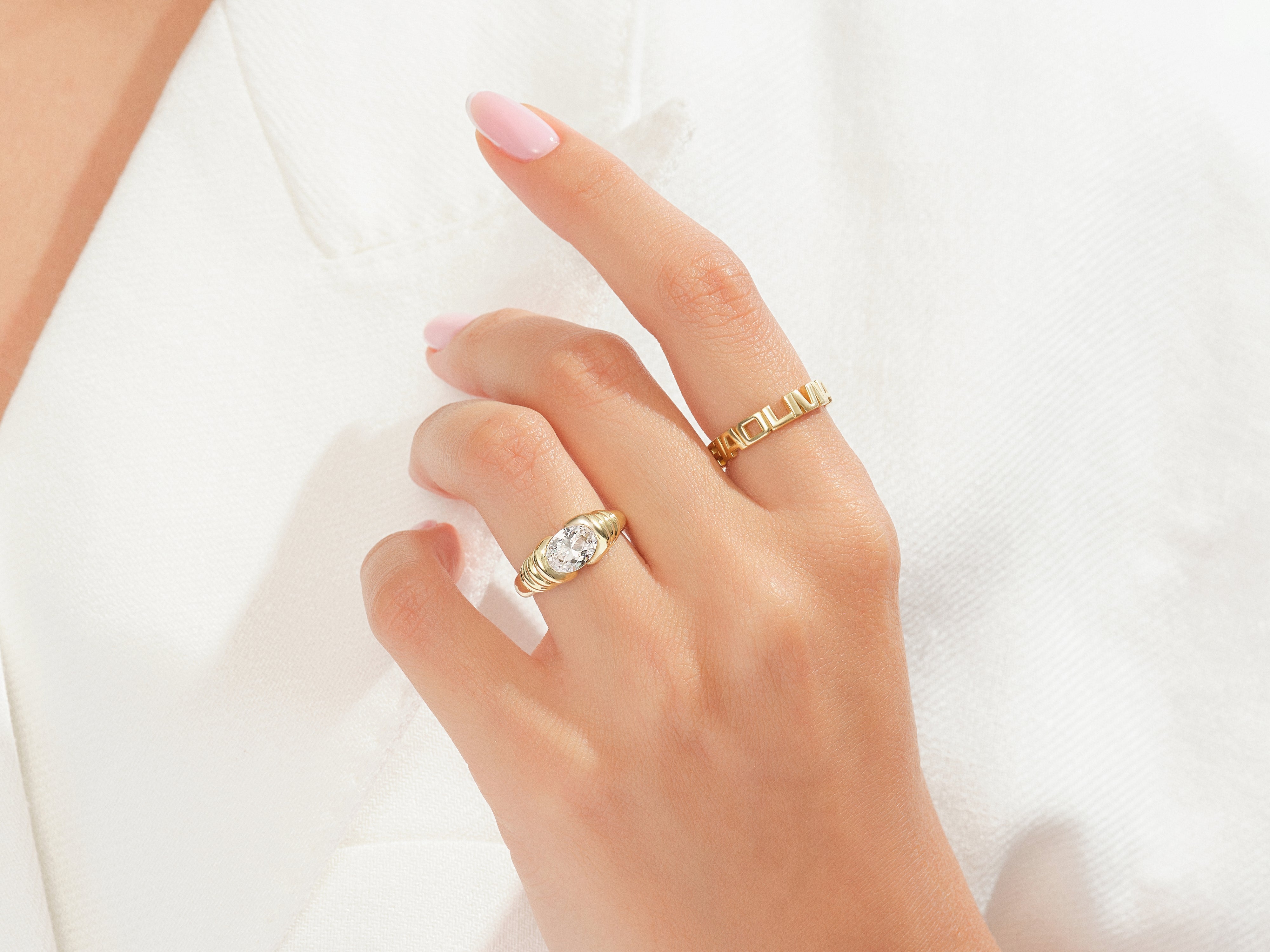 Gold rings with diamonds and geometric design on hand