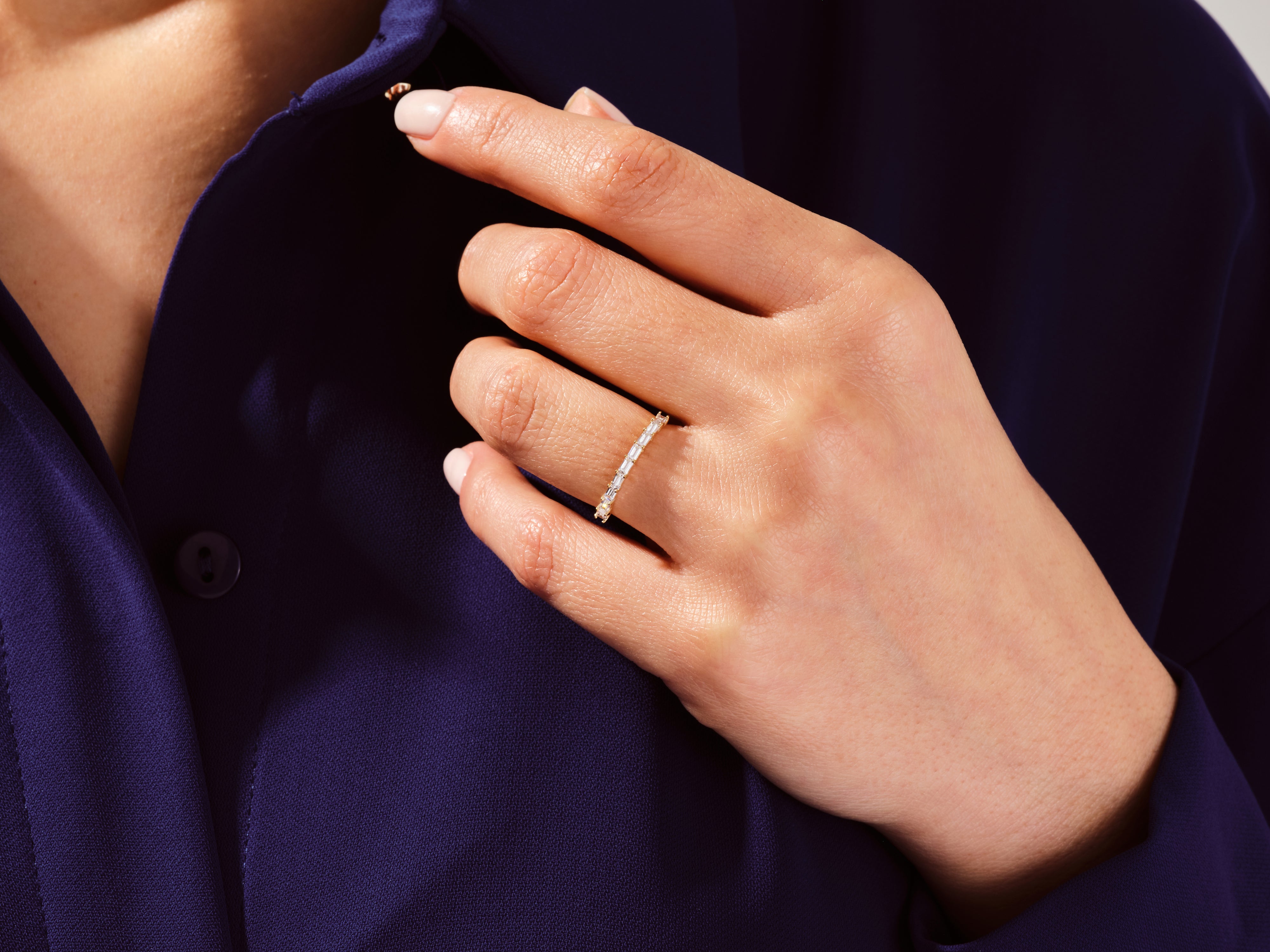 Diamond baguette eternity ring on hand, fine jewelry