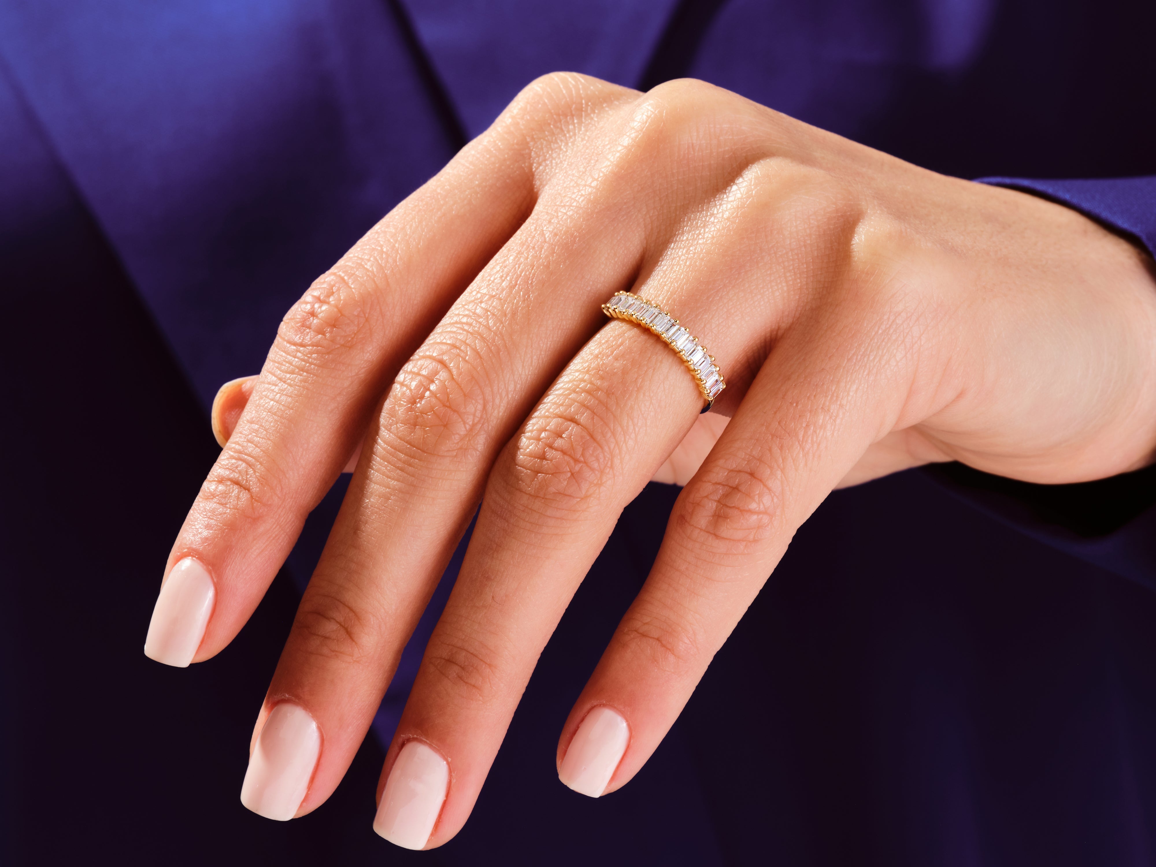 Gold baguette diamond ring on hand