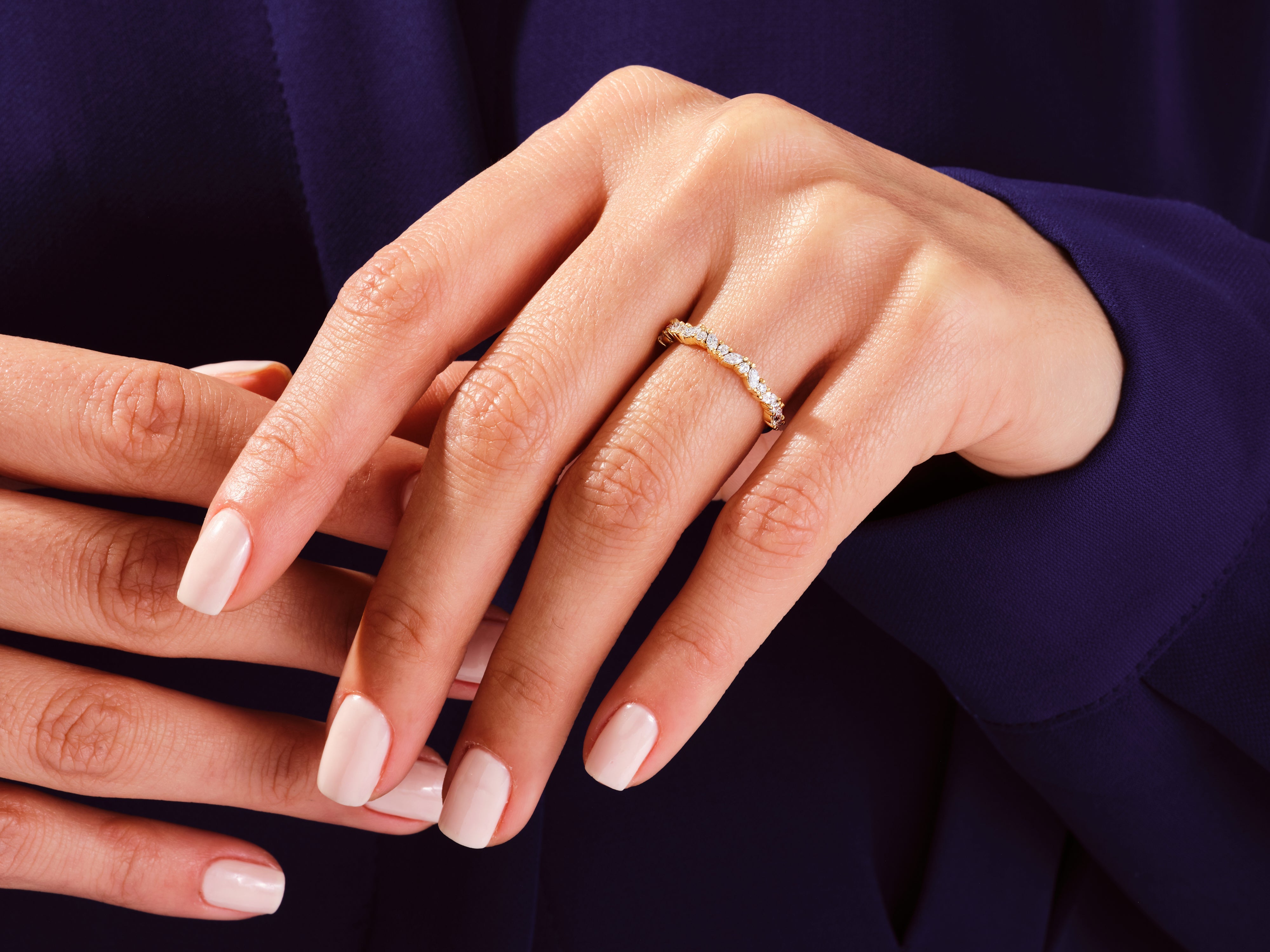 Diamond eternity ring on a woman's hand, jewelry