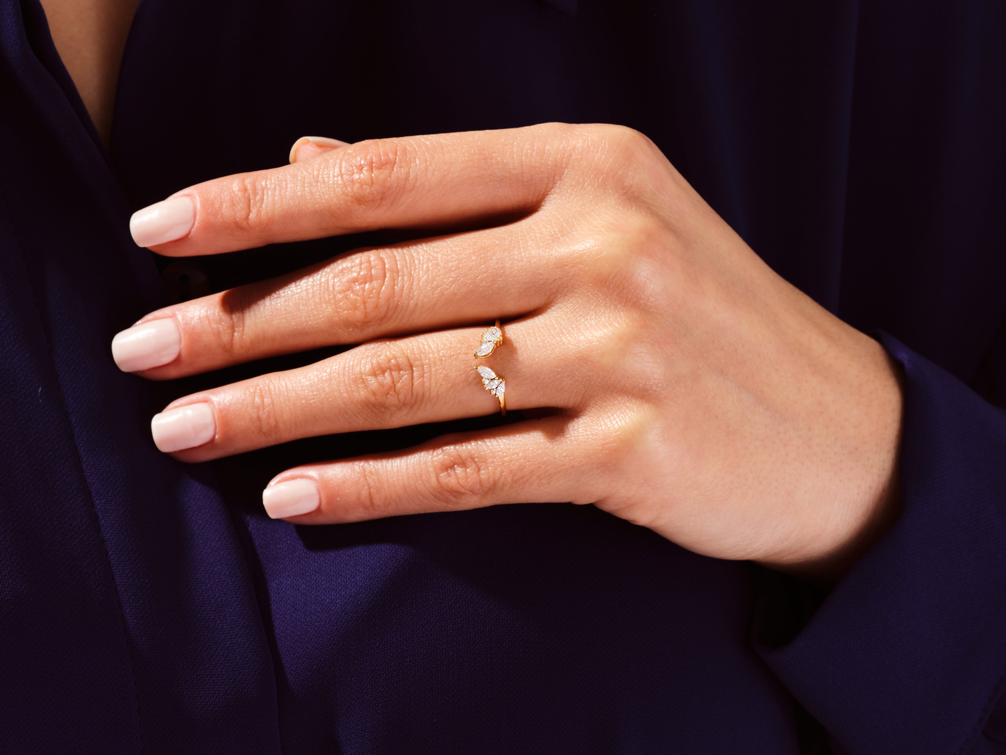 Gold butterfly ring with diamonds on a woman's hand