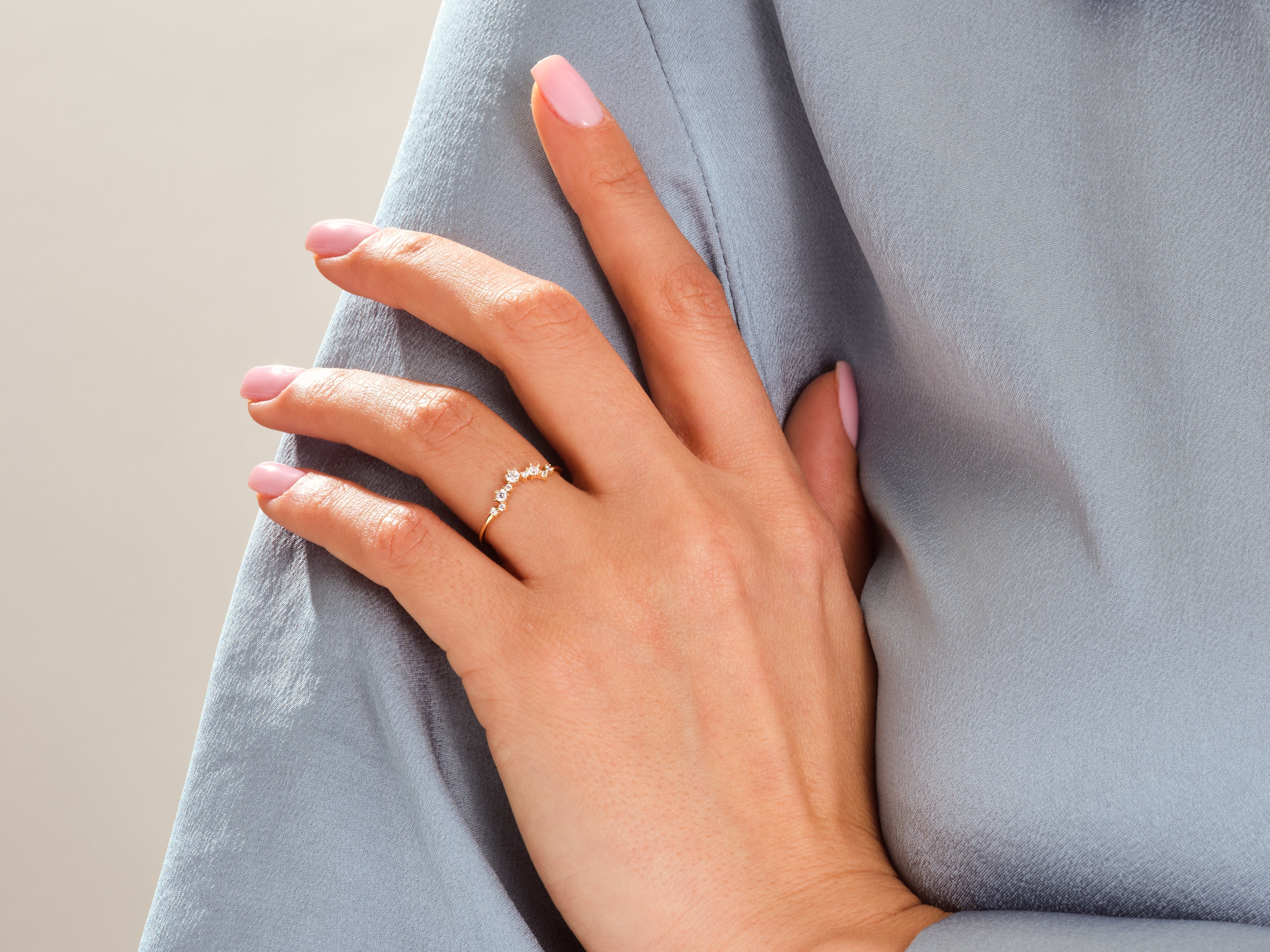 Delicate gold ring with diamonds on a woman's hand