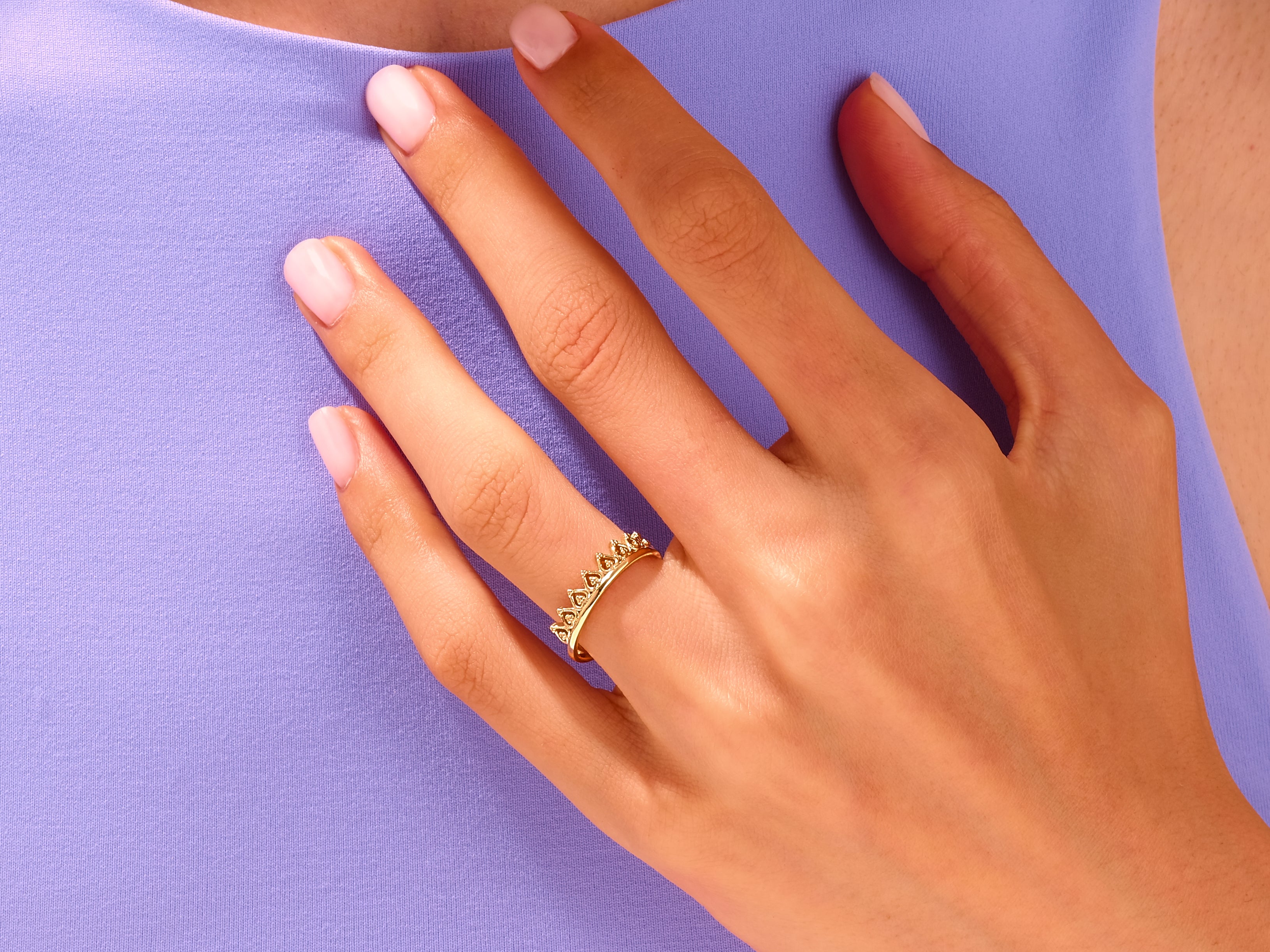 Gold crown ring on a woman's finger, jewelry