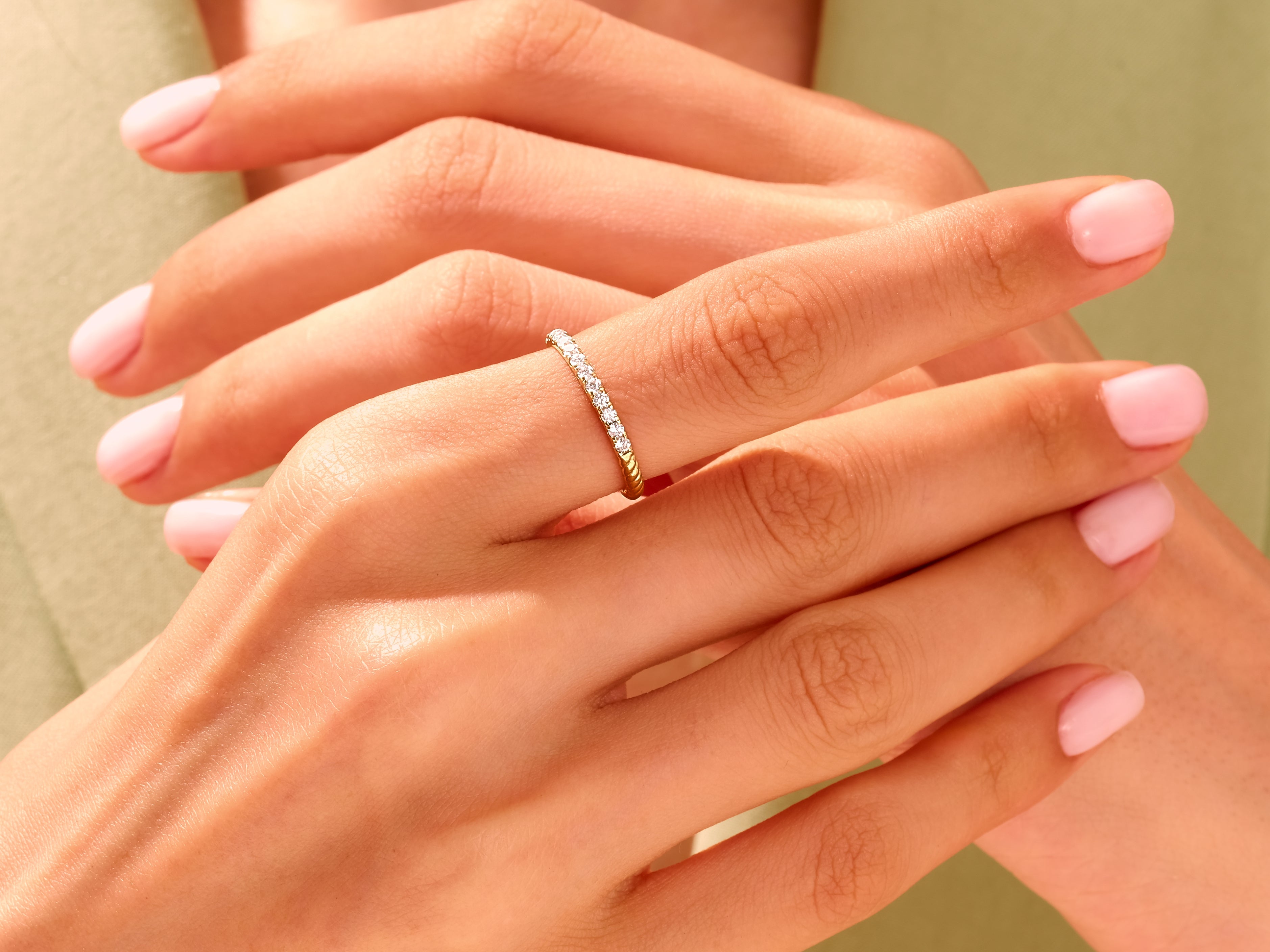 Diamond band ring on a hand, jewelry photography