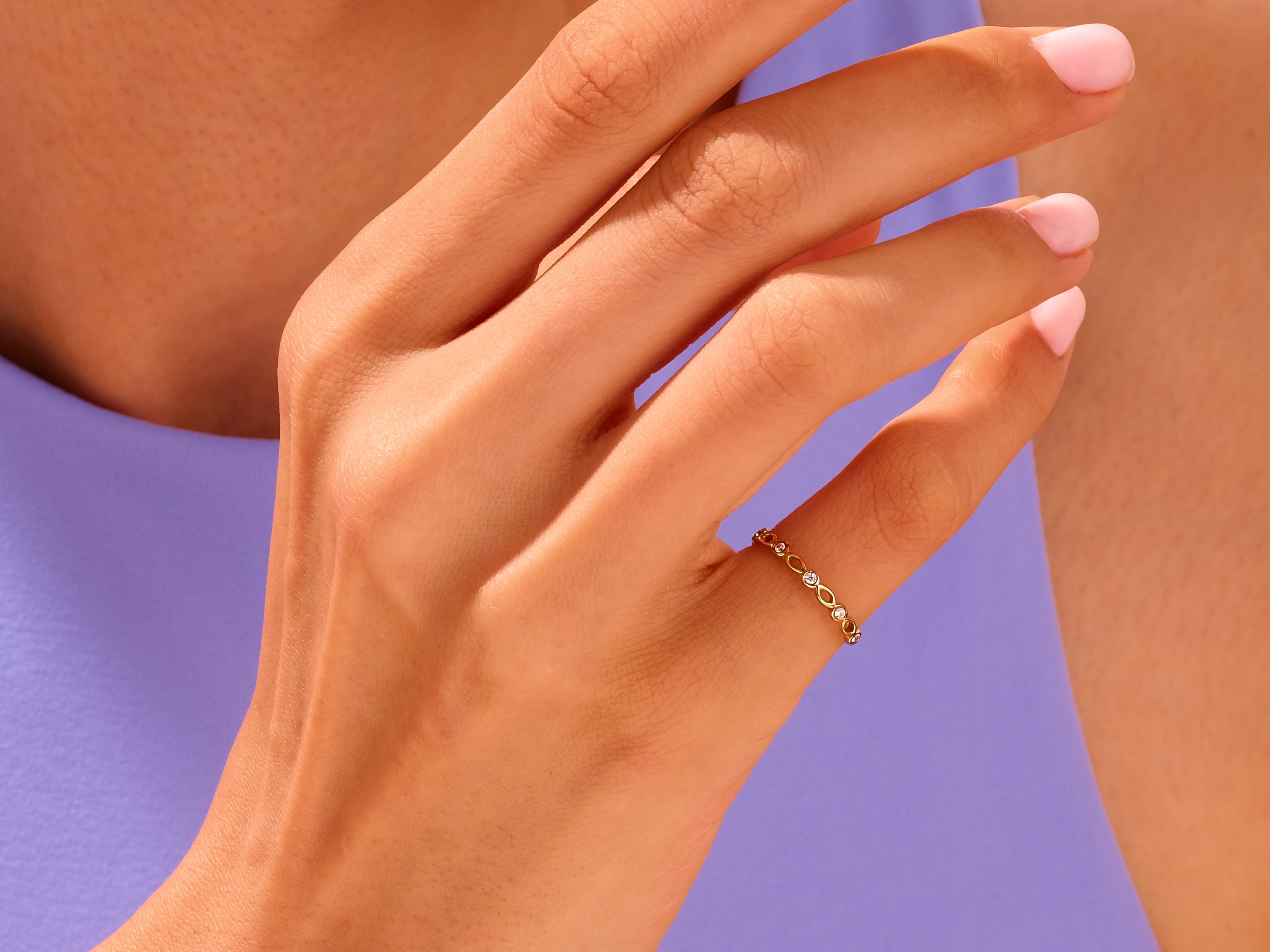 Delicate gold ring with diamonds on a woman's finger