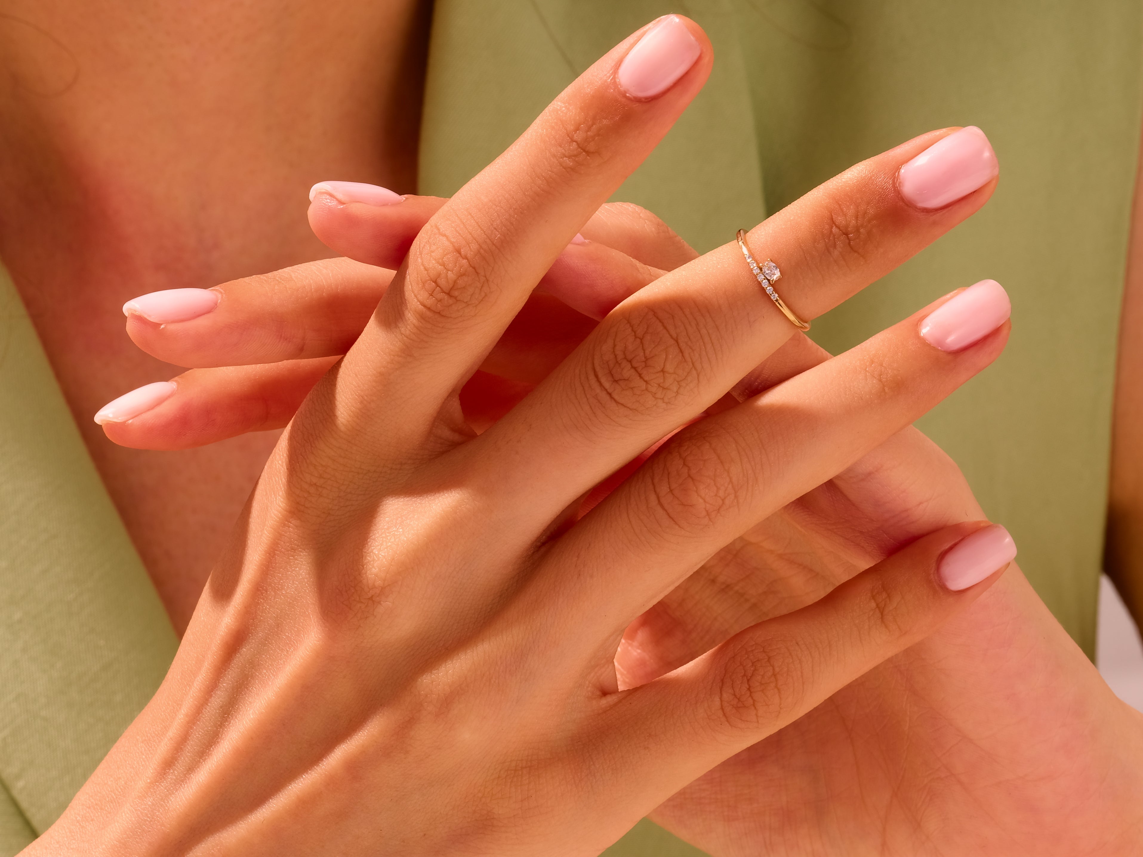 Delicate gold diamond ring on a woman's finger, jewelry