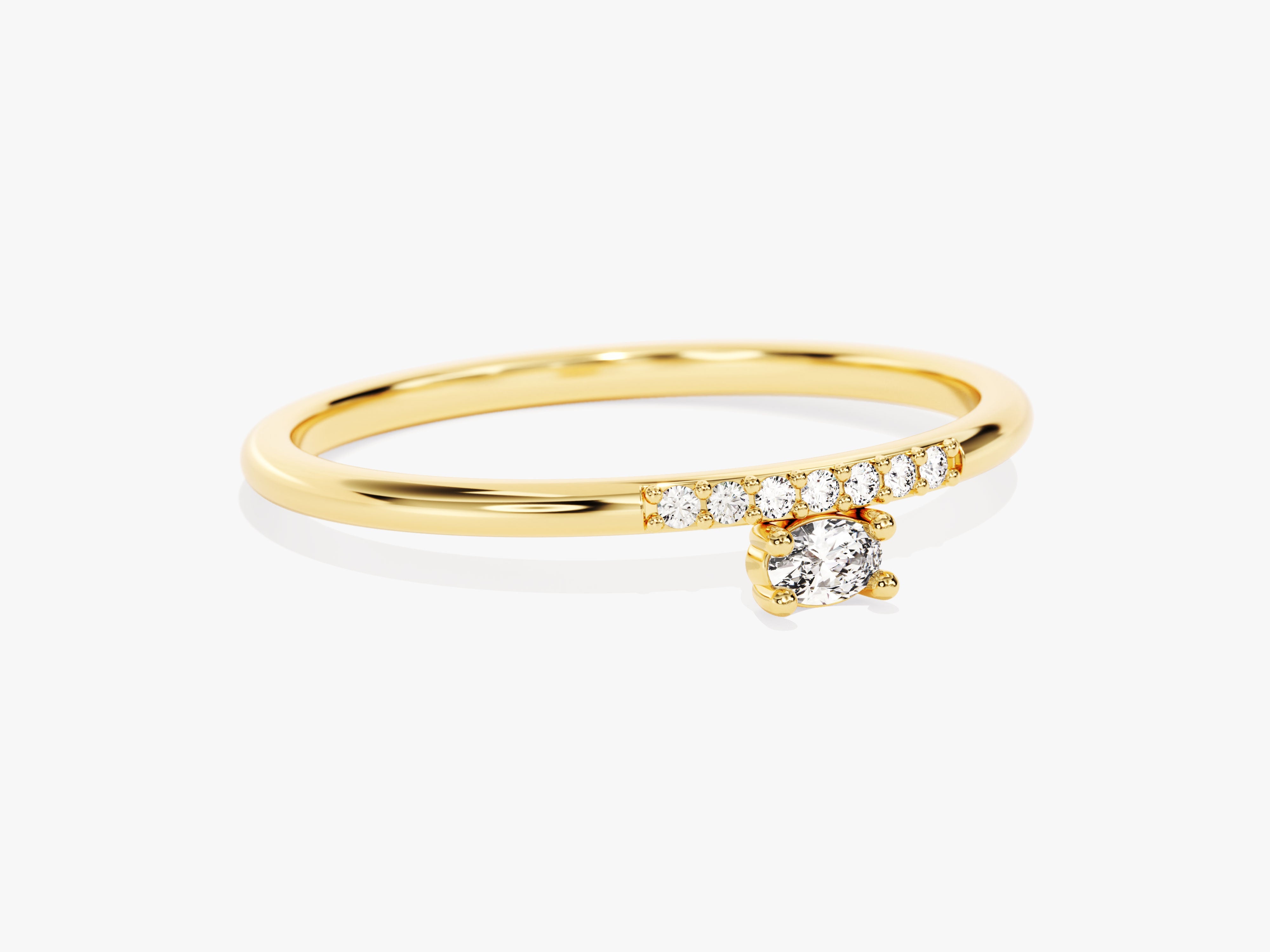 Gold diamond ring with a dangling solitaire diamond and pave band