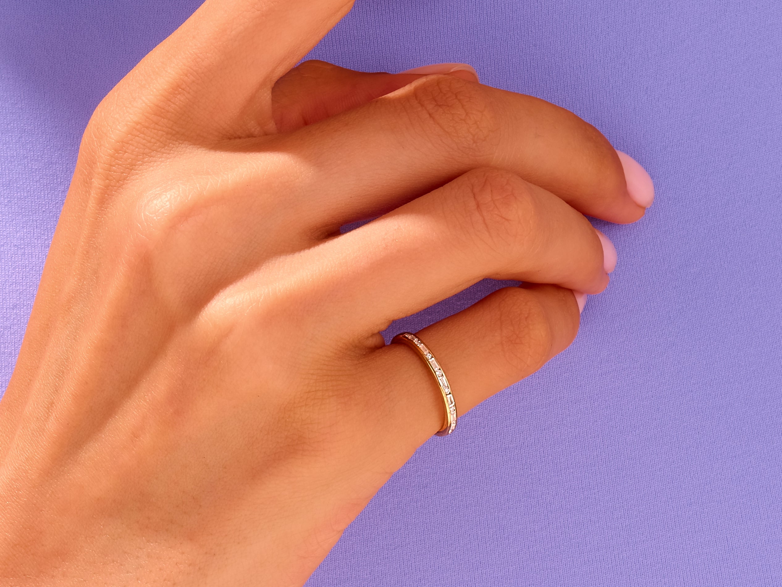 Gold baguette diamond ring on hand