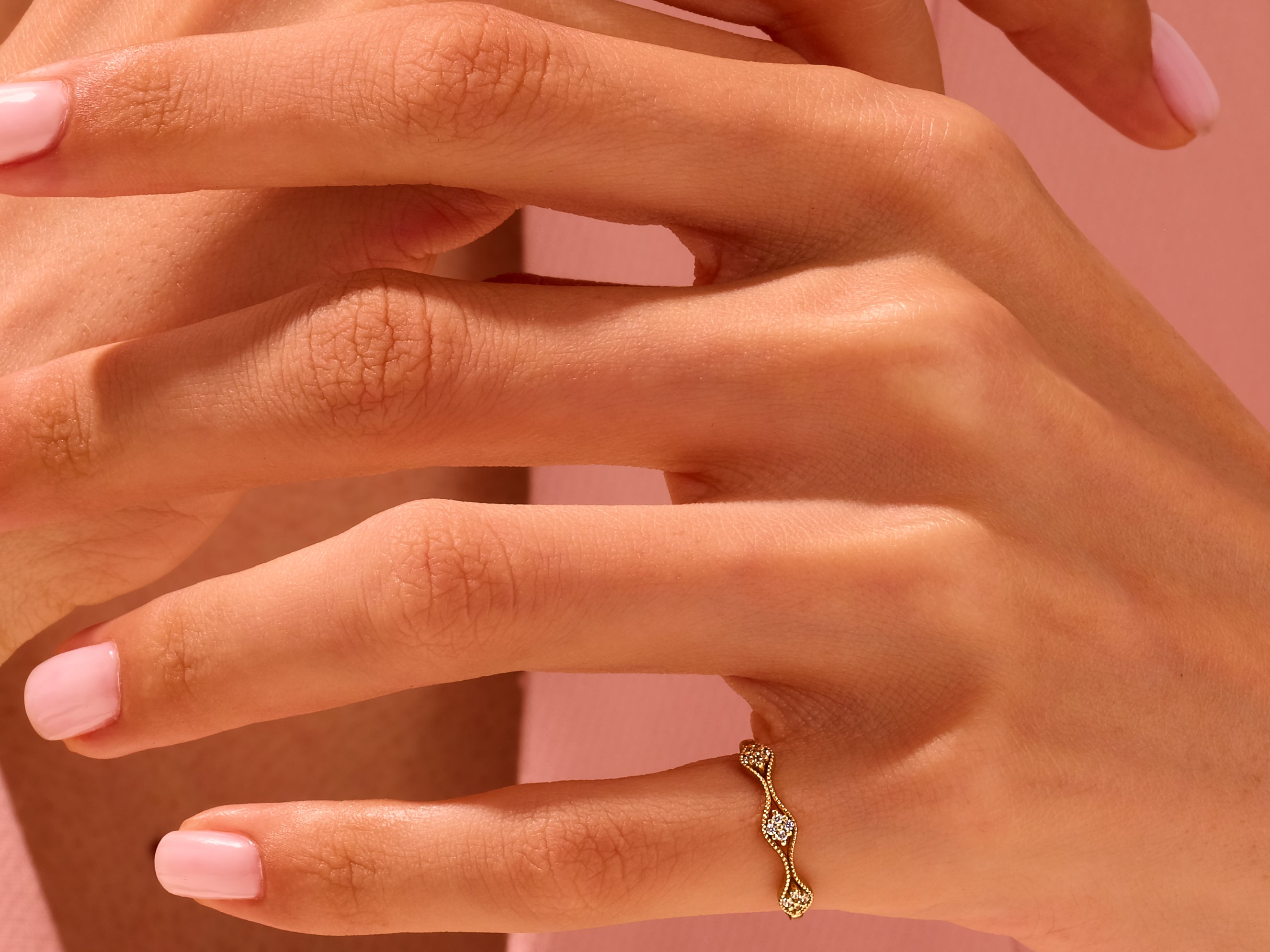 Delicate gold diamond ring on a woman's hand